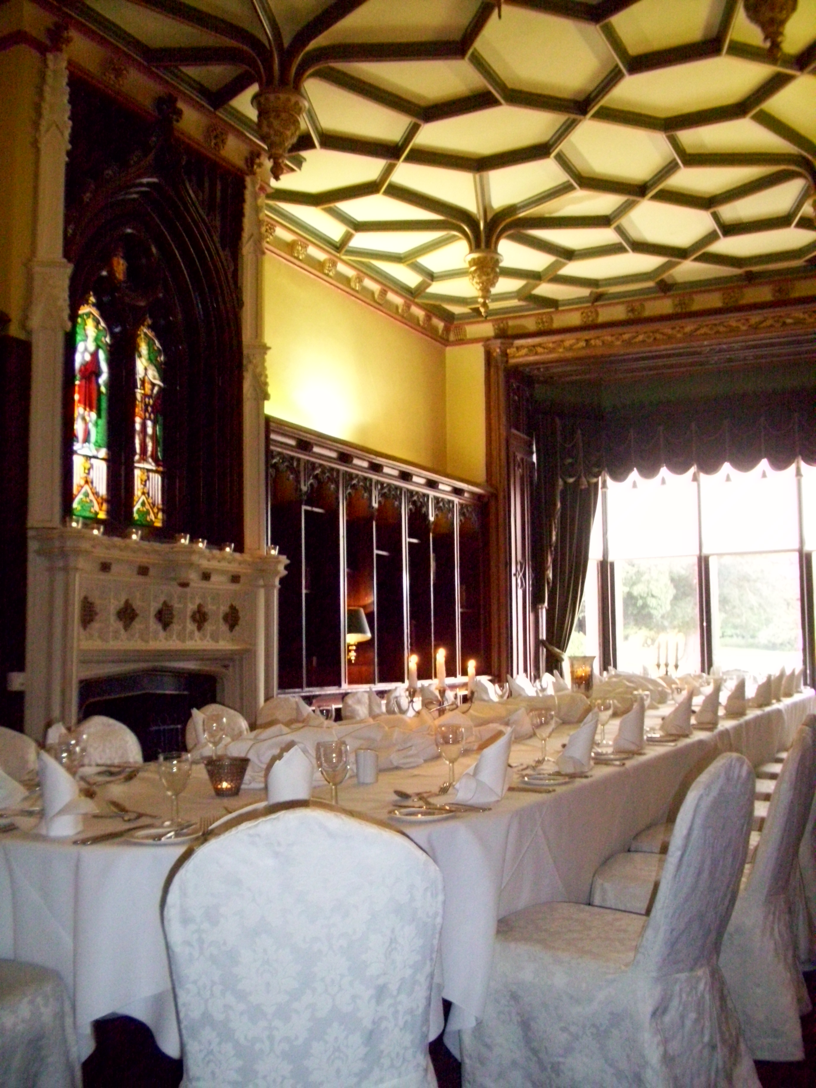 Elegant banquet hall at Ettington Park Hotel with stained glass, perfect for weddings and events.
