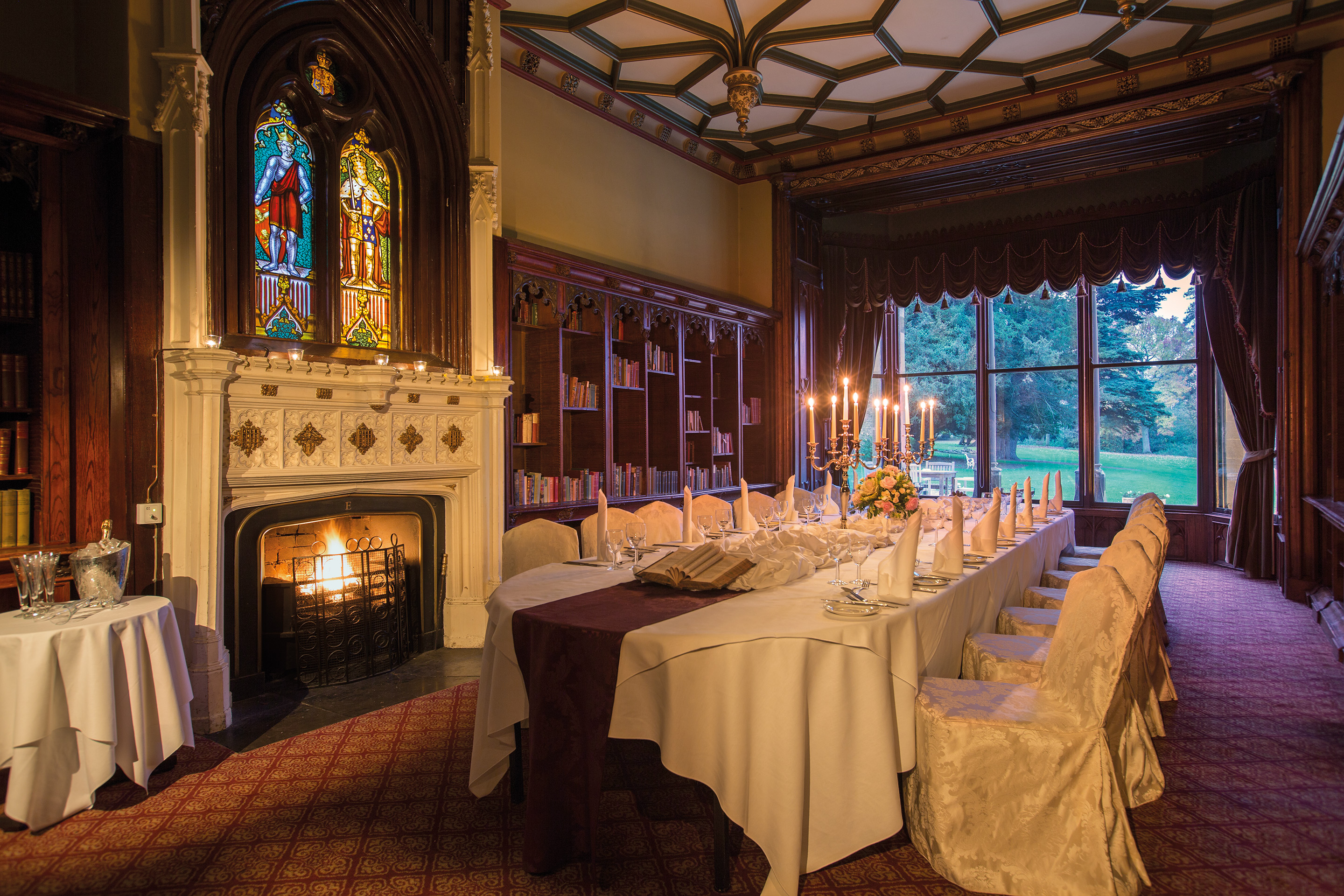 Elegant meeting space with dining table, stained glass, ideal for upscale events.