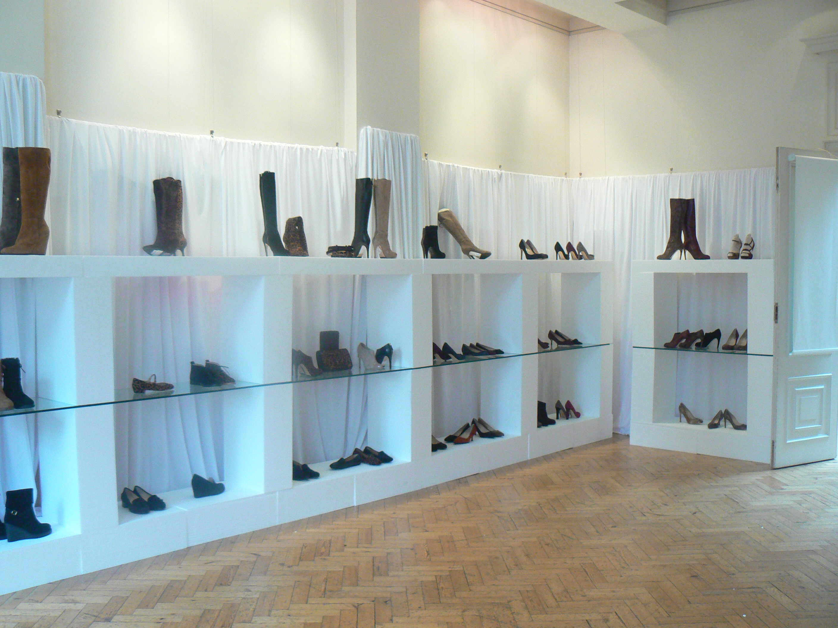 Stylish shoe display in a well-lit venue for a fashion event at The Hellenic Centre.