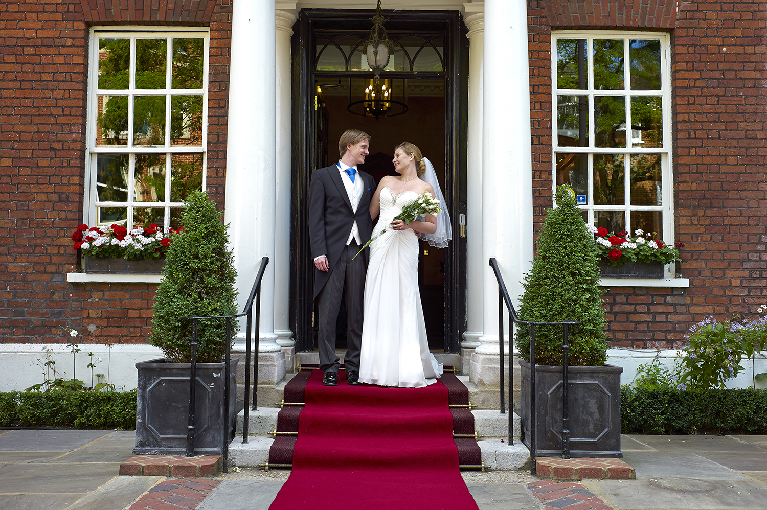 Couple exiting Princess Suite, elegant venue with red carpet, perfect for weddings and events.
