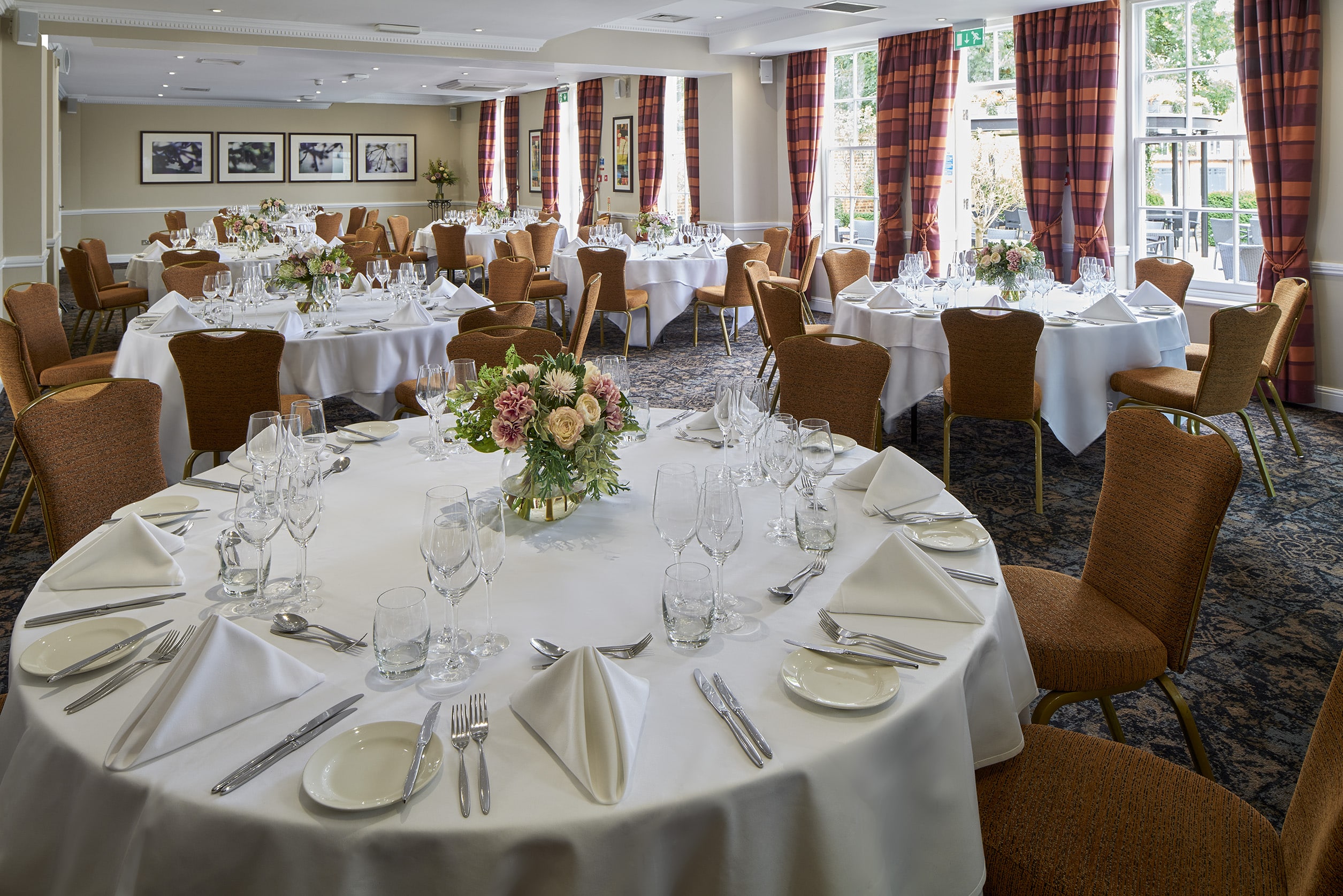 Elegant Princess Suite banquet room with floral centerpieces for weddings and corporate events.