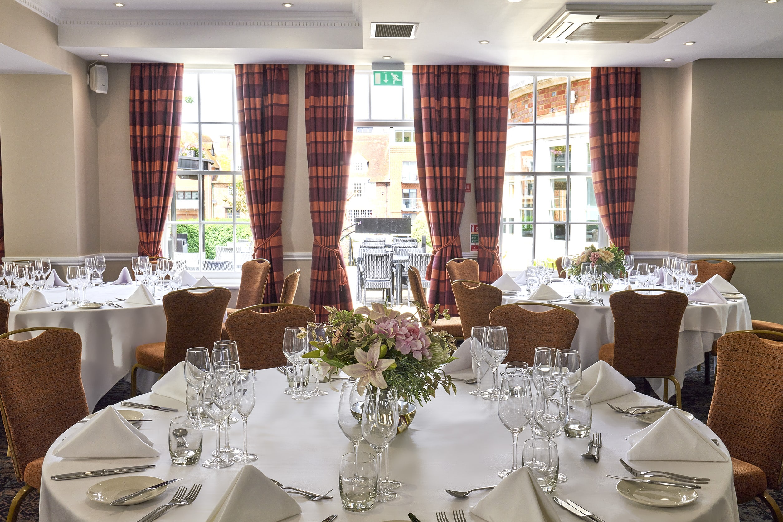 Elegant Princess Suite banquet room with round tables, perfect for weddings and corporate events.