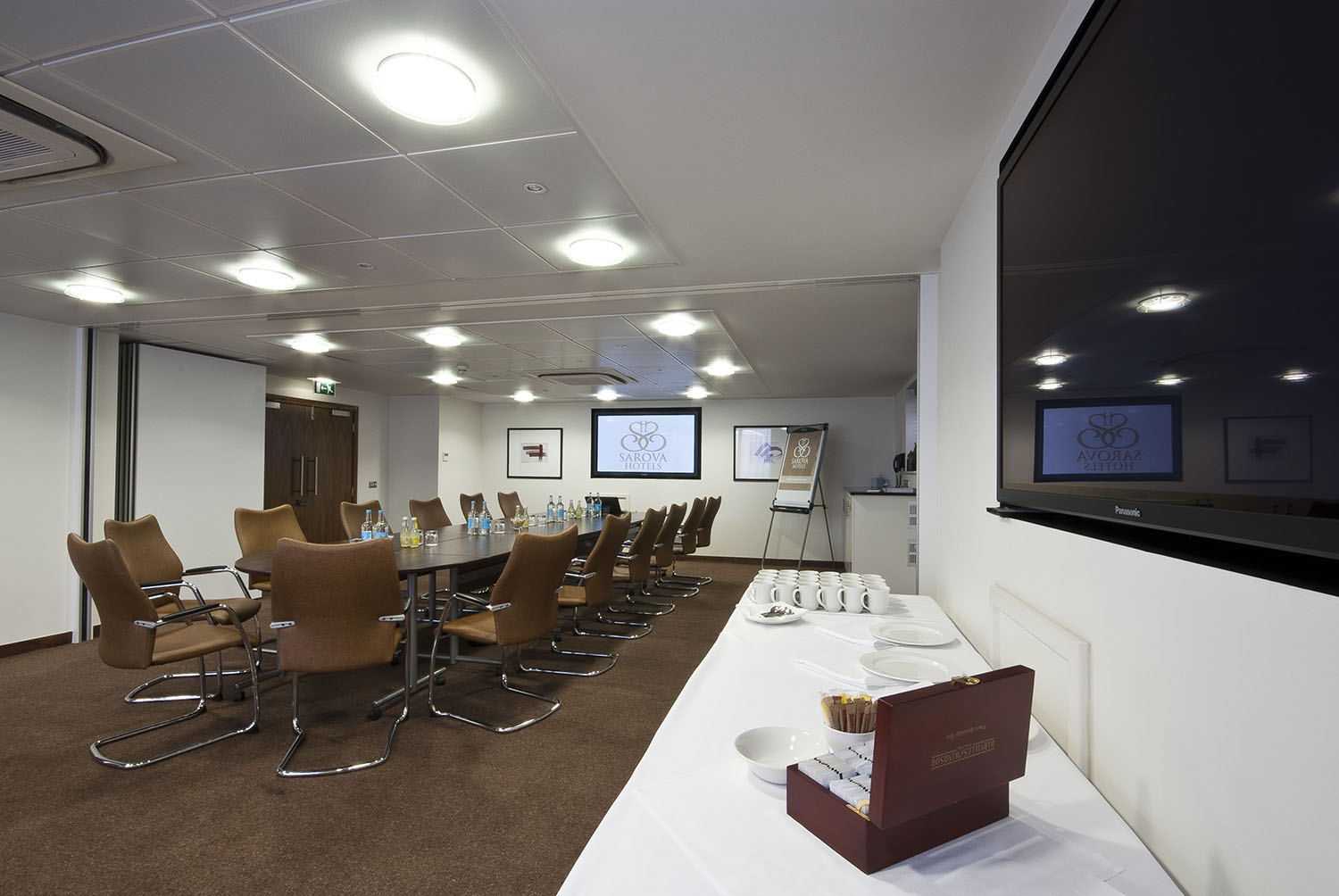 Buckingham Suite meeting room with large table, ideal for professional events and presentations.