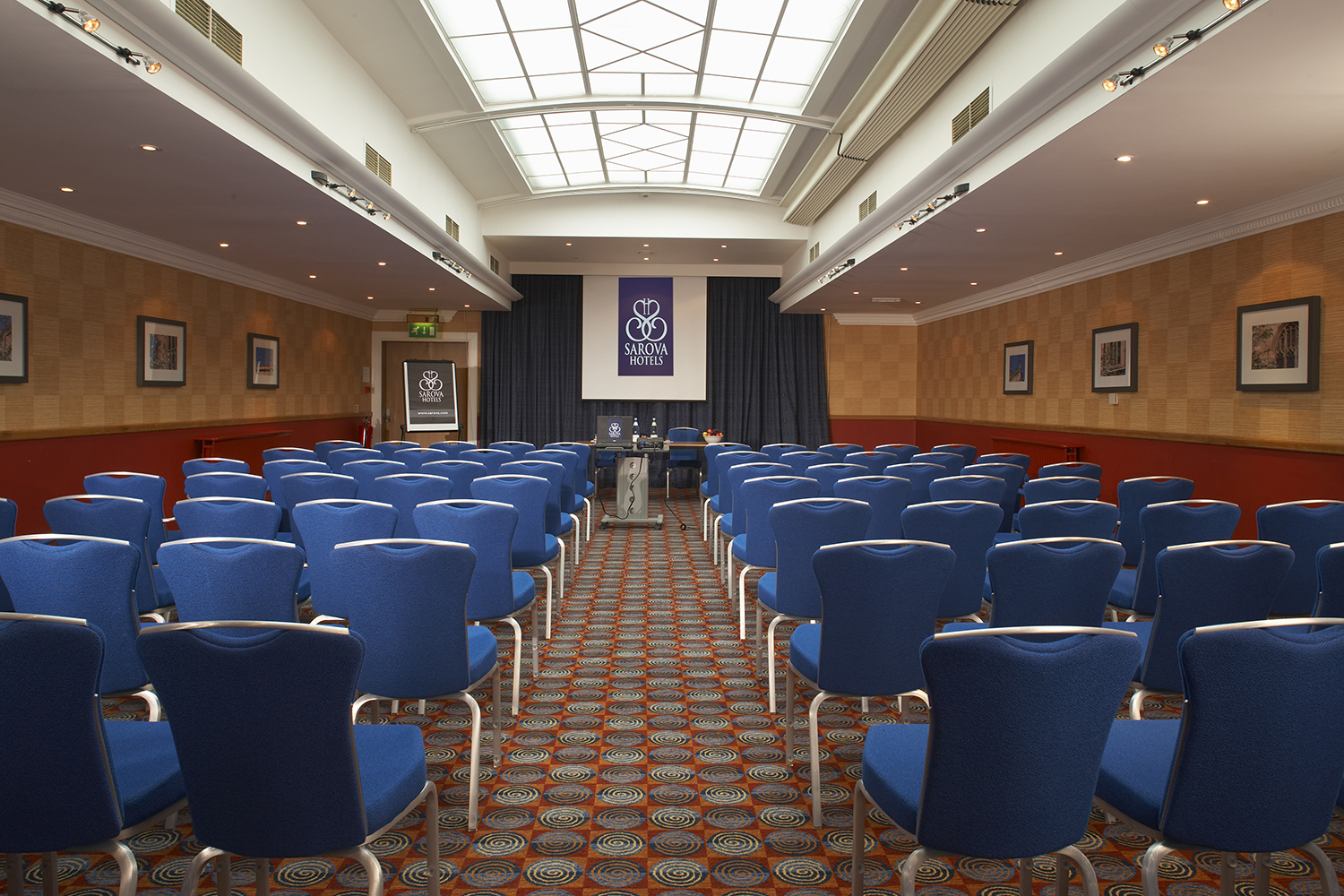 Shaw Suite meeting room with blue chairs, ideal for conferences and workshops.