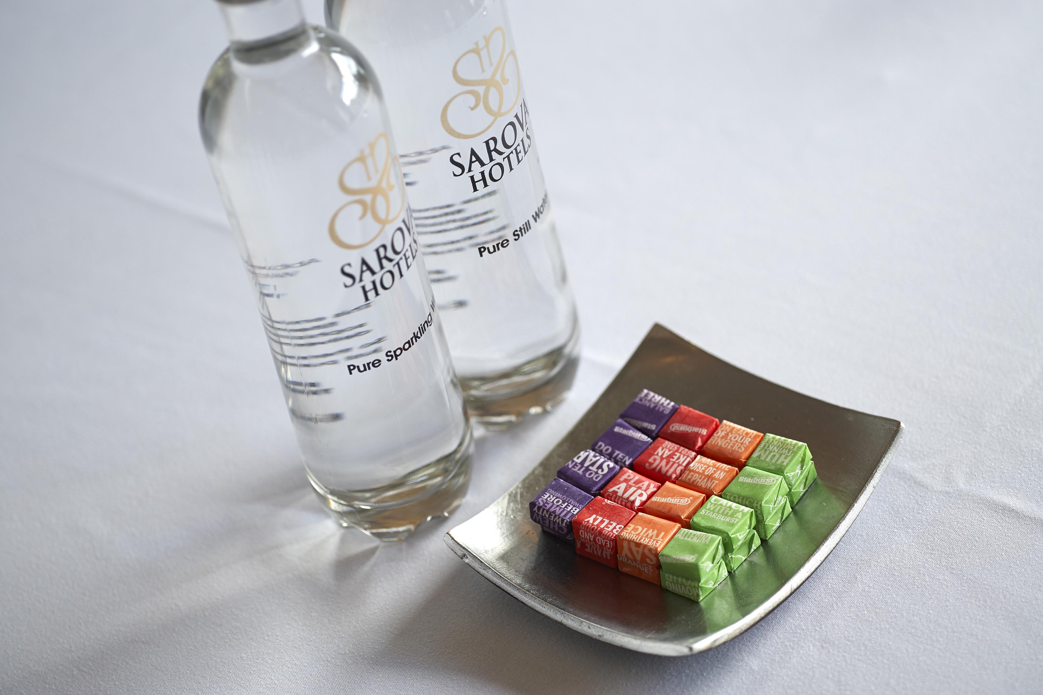 Malvern Suite at The Abbey Hotel with branded water and colorful candies for events.