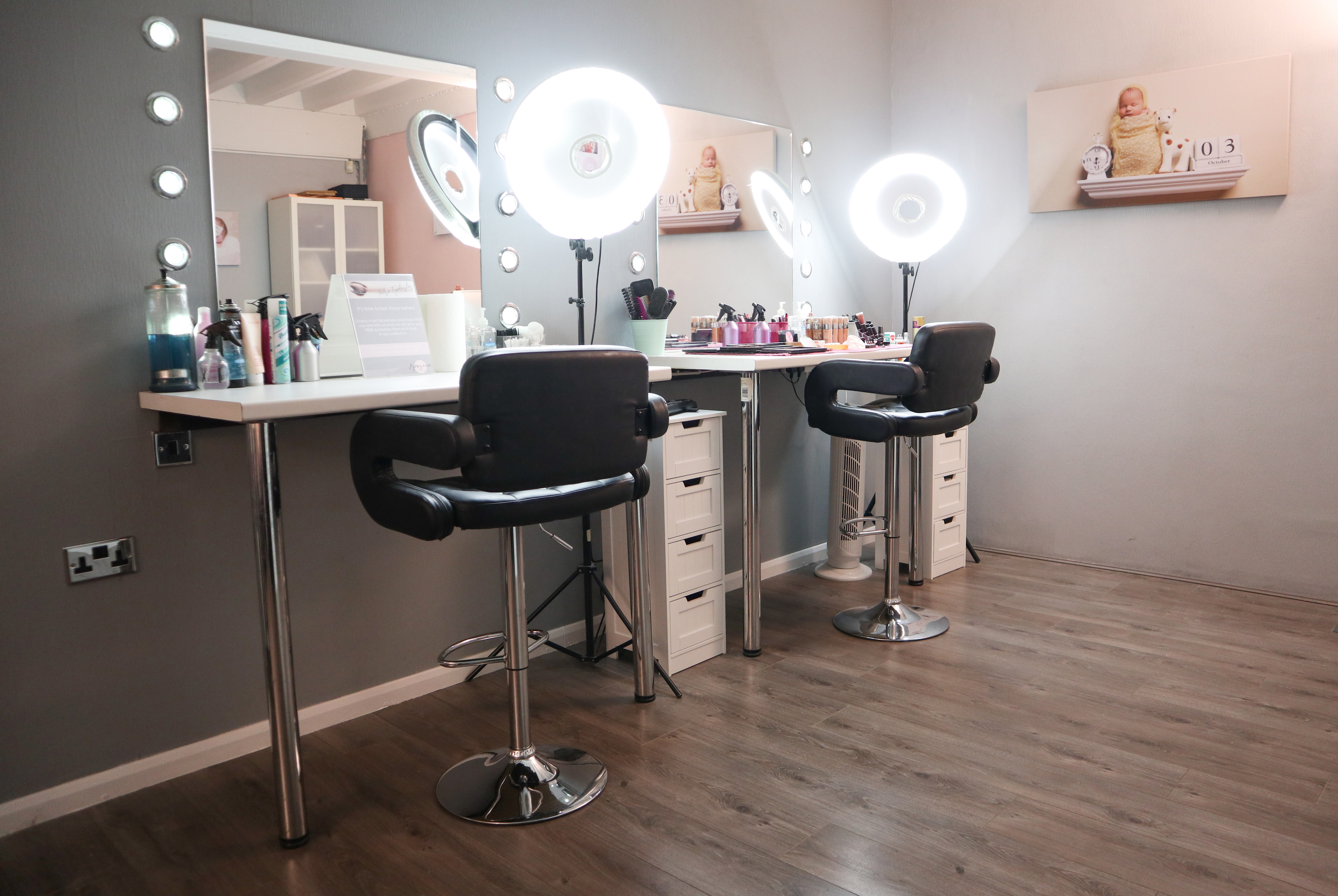 Makeup station with bright ring lights for pre-event beauty preparations at Xposure Studios.