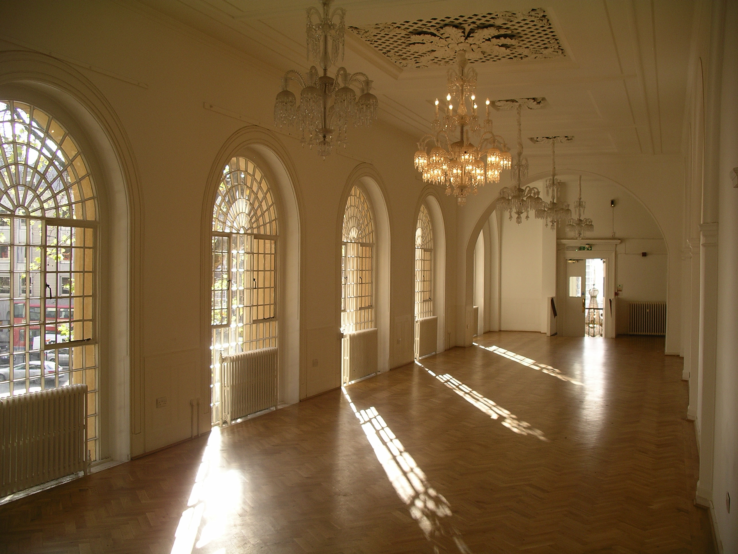 Elegant event venue with arched windows, ideal for meetings and gatherings.