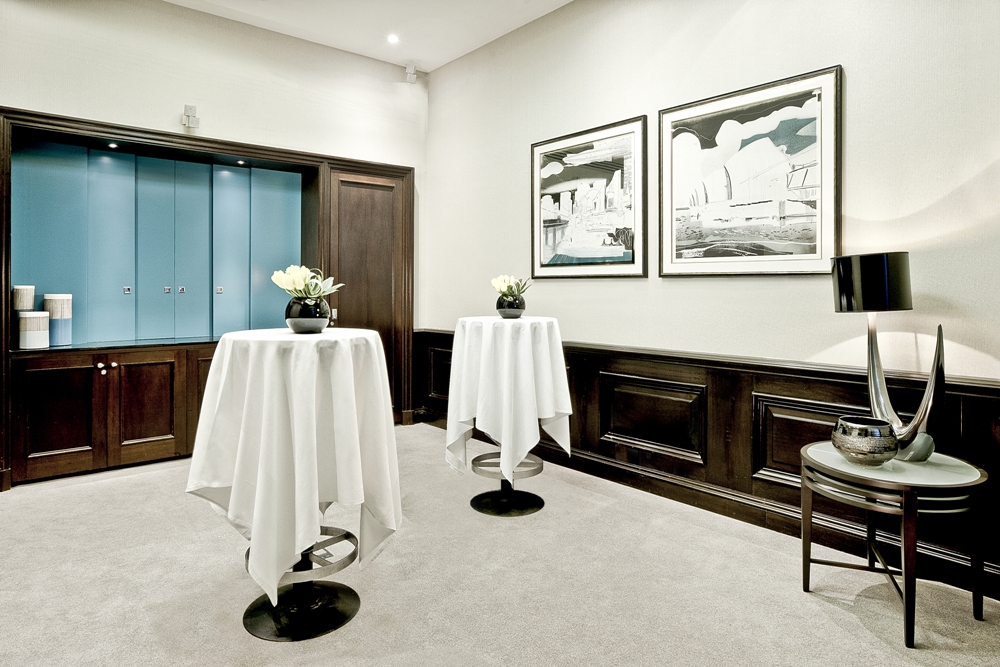 Elegant event space at Threadneedles Hotel, London with high-top tables for networking.