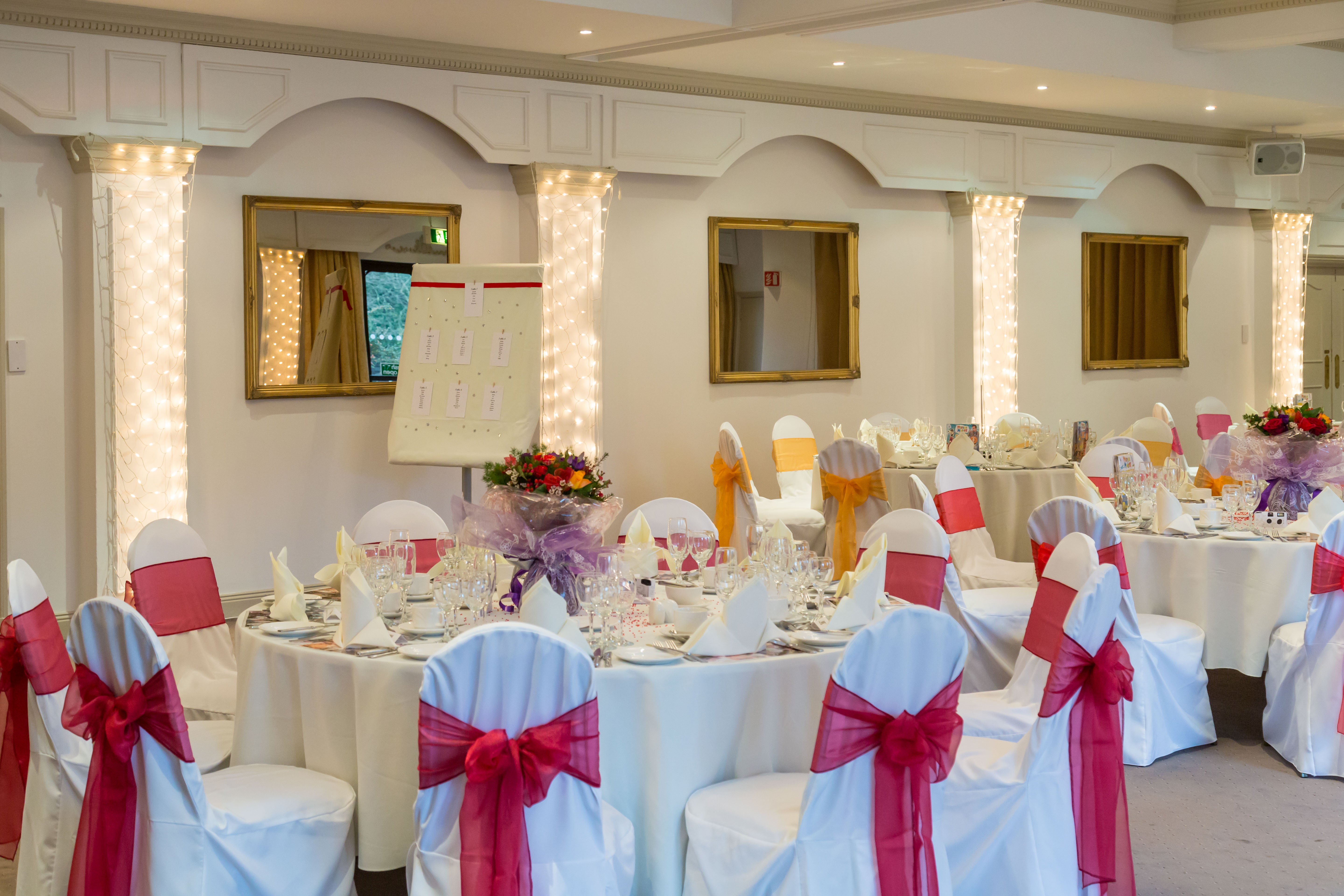 La Seigneurie Suite at St Pierre Park Hotel, elegant wedding event space with floral centerpieces.