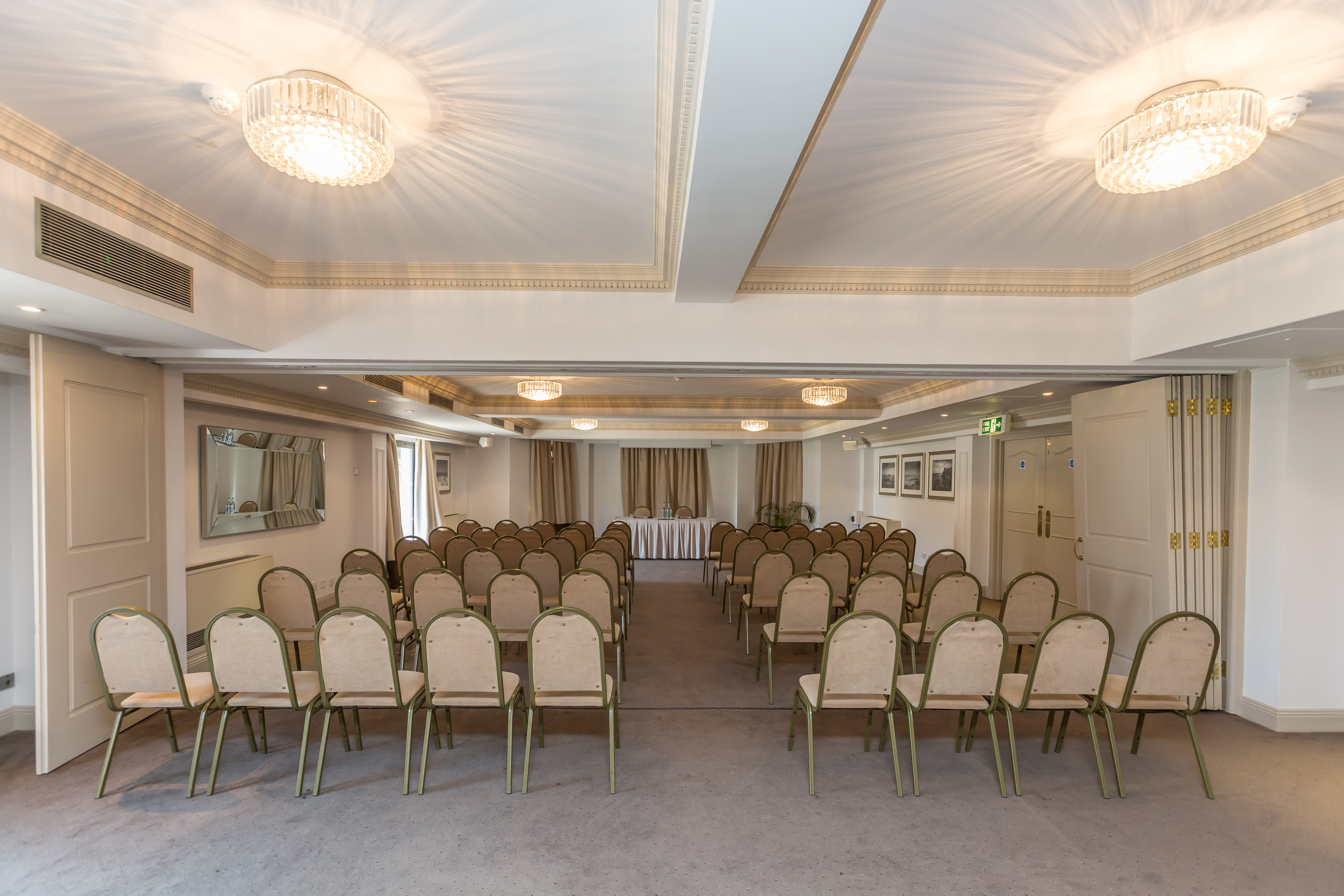 Victor Hugo Suite meeting space with elegant chairs, ideal for seminars and presentations.