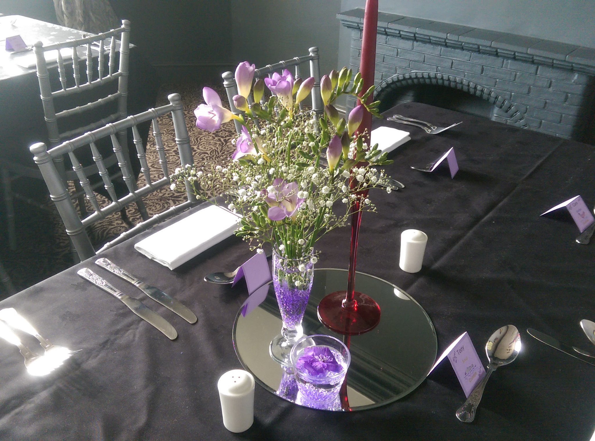 Elegant table setting with purple flowers for formal events at The Whisky Room.