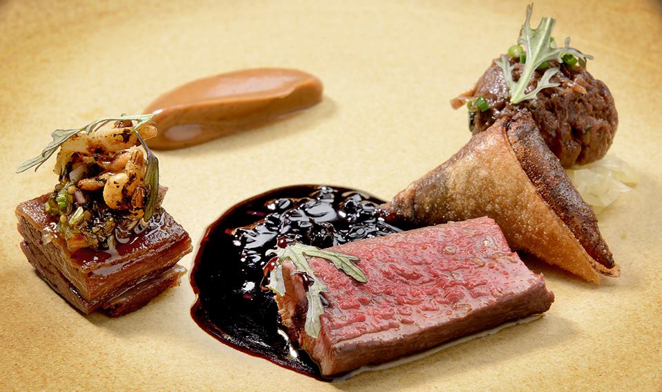Gourmet dish with tender meat and artistic garnishes at Restaurant Story event.