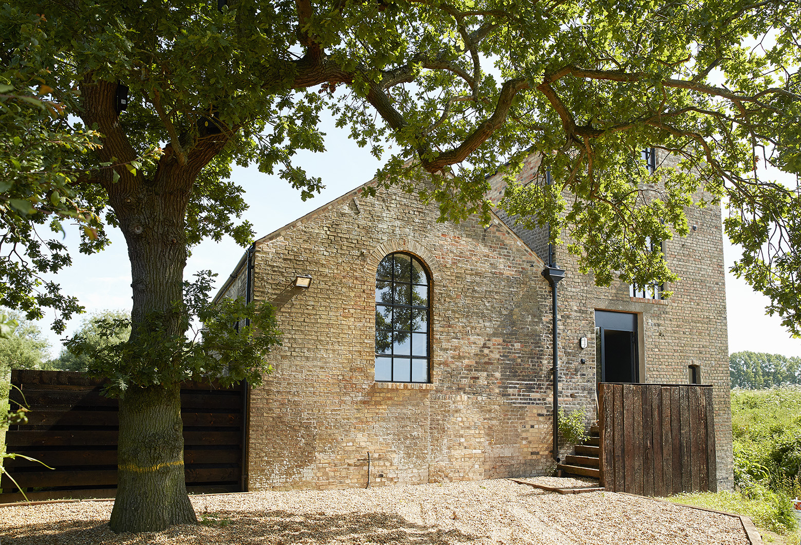 Charming rustic venue with large windows for intimate gatherings and outdoor events.