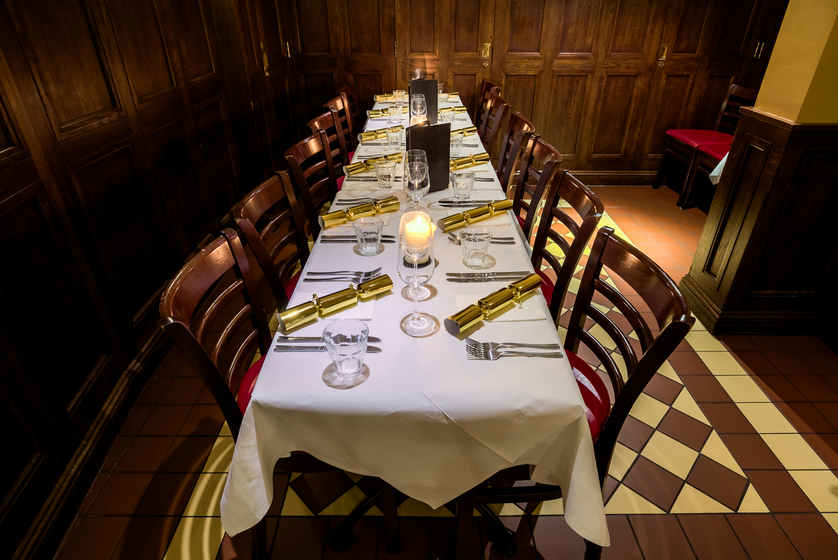 Elegant dining table setup for corporate dinner at Boulevard Brasserie with candles.