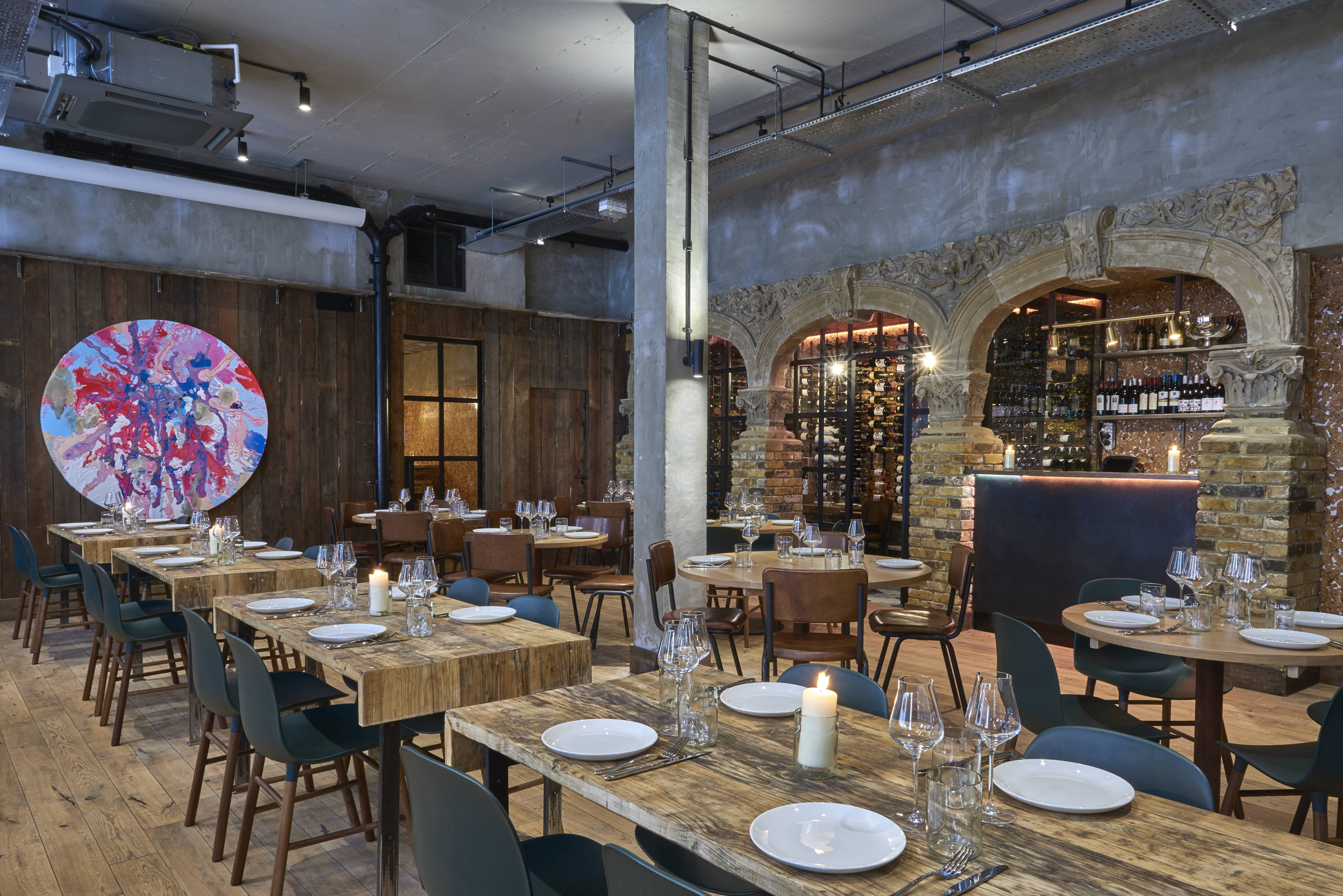 Stylish private event space with rustic wood tables for corporate gatherings and celebrations.