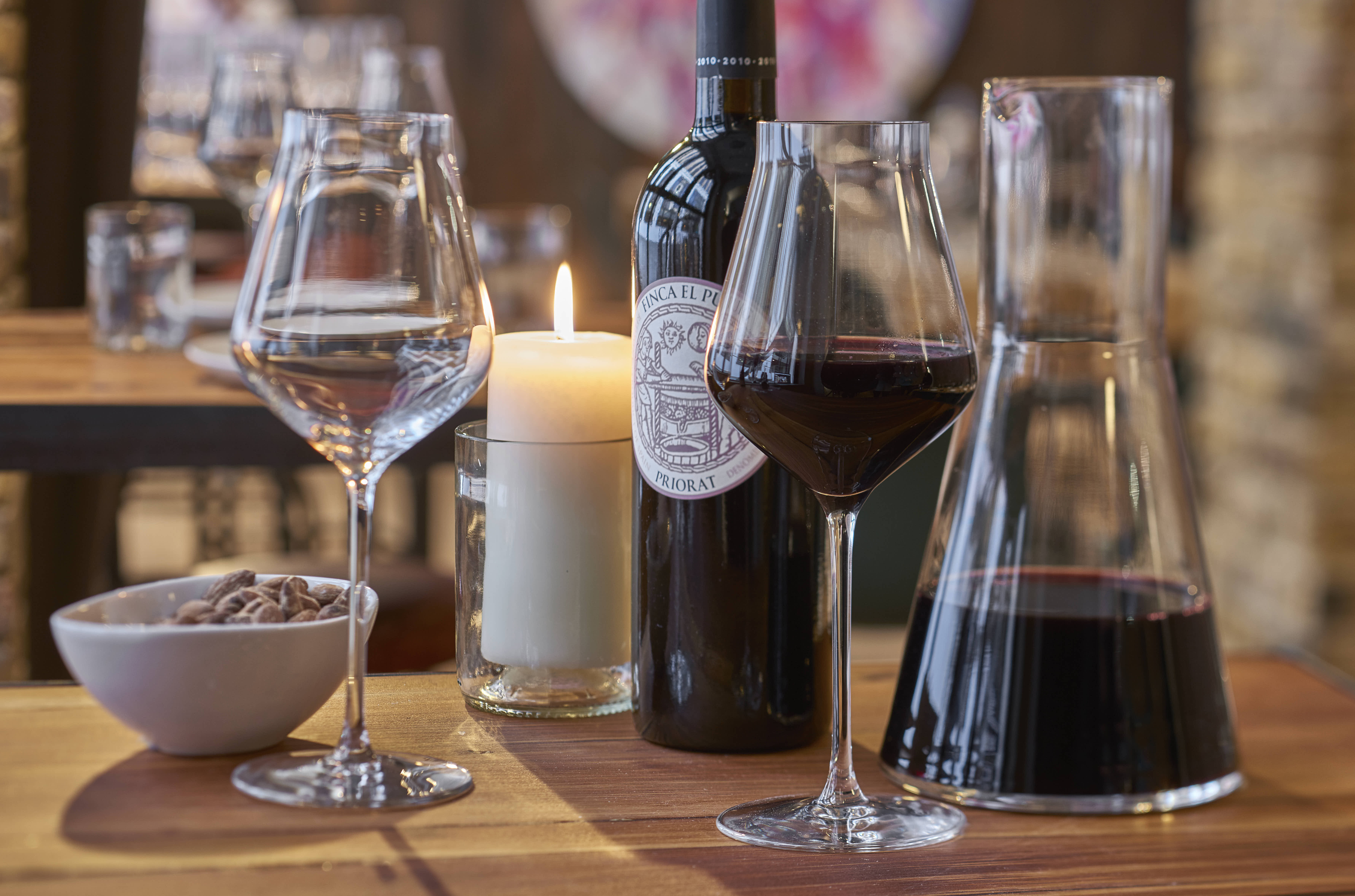 Elegant table setting for networking event with fine wine and candlelight ambiance.