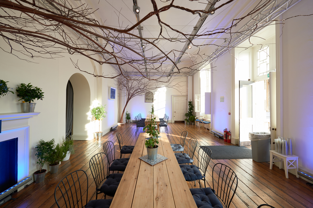 Elegant event space in Somerset House with wooden table, ideal for meetings and gatherings.