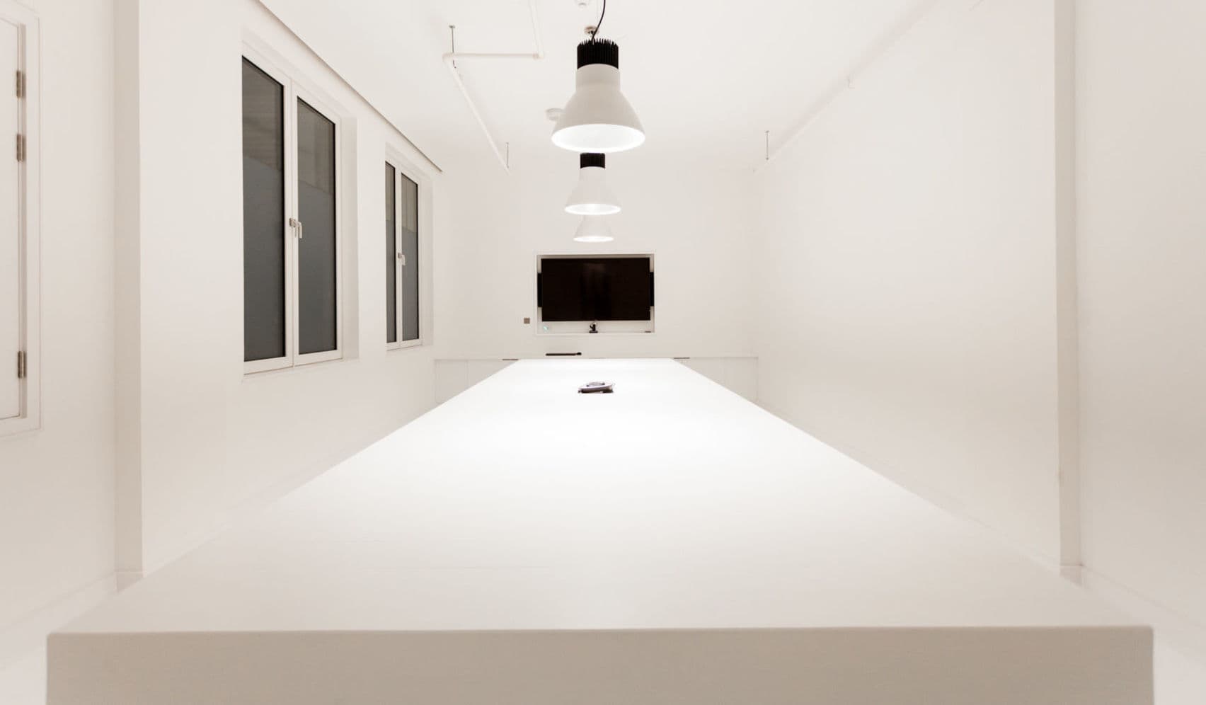 Cupertino Meeting Room with white table, ideal for modern meetings and presentations.
