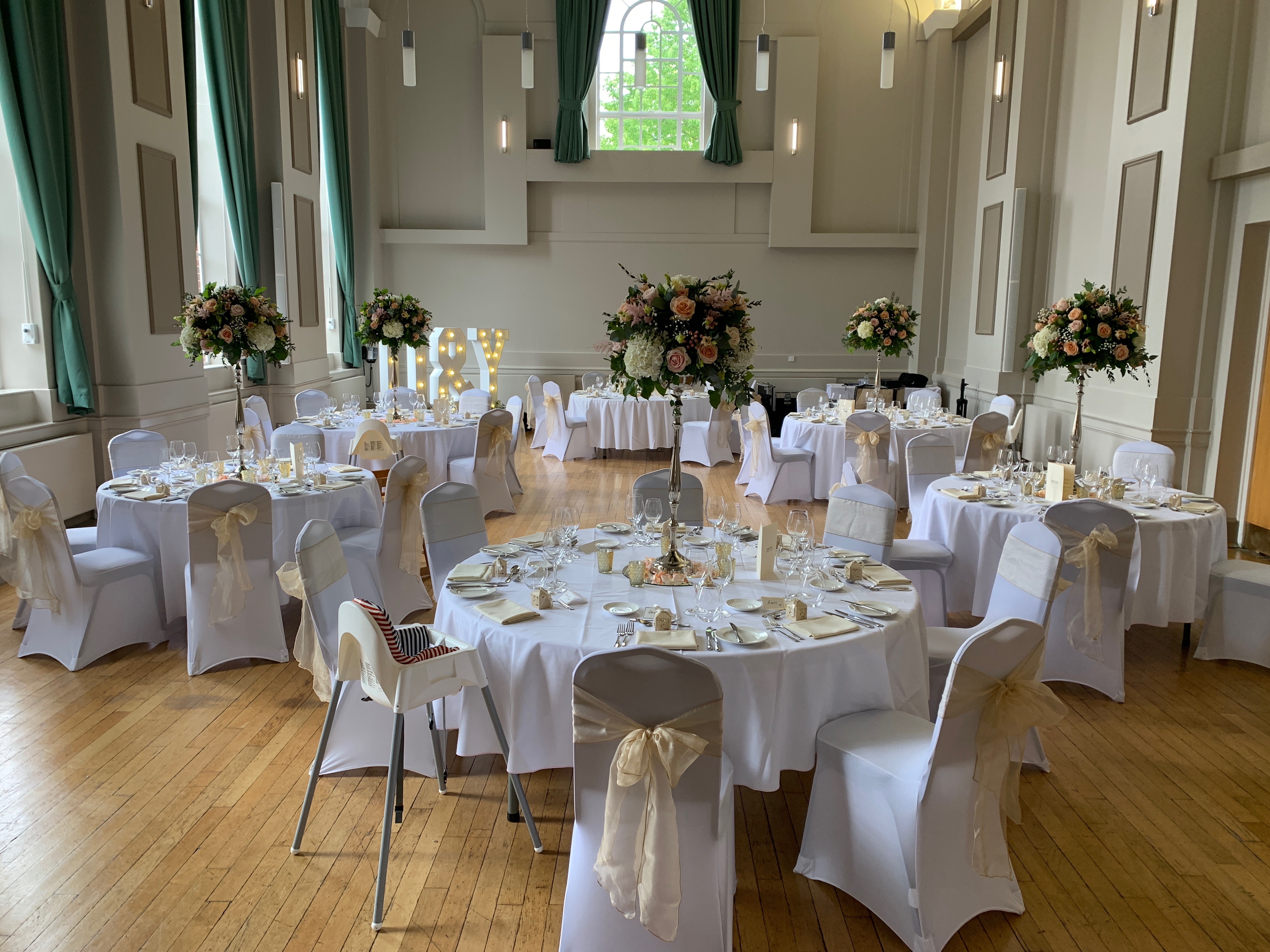 Elegant Herringham Hall event space with floral centerpieces for weddings and gatherings.