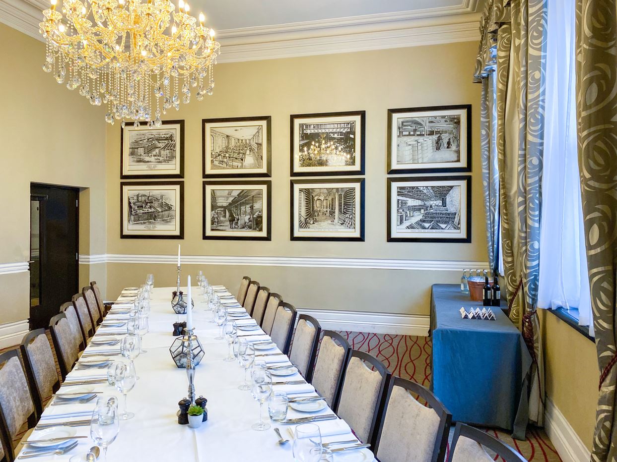 Sophisticated Melville Room with elegant dining setup for exclusive meetings and events.