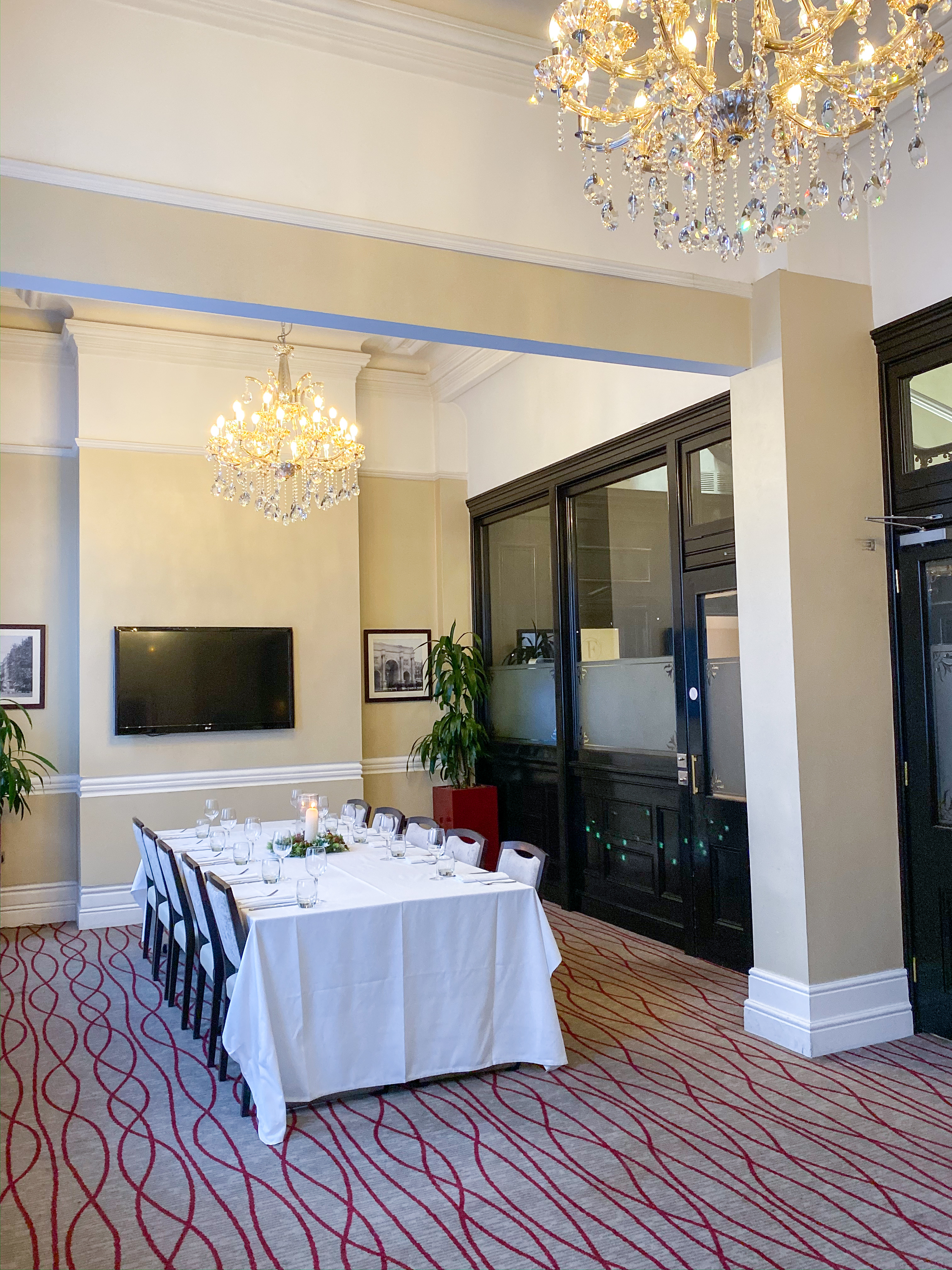 Worsely Room: elegant meeting space with chandelier for corporate events and gatherings.