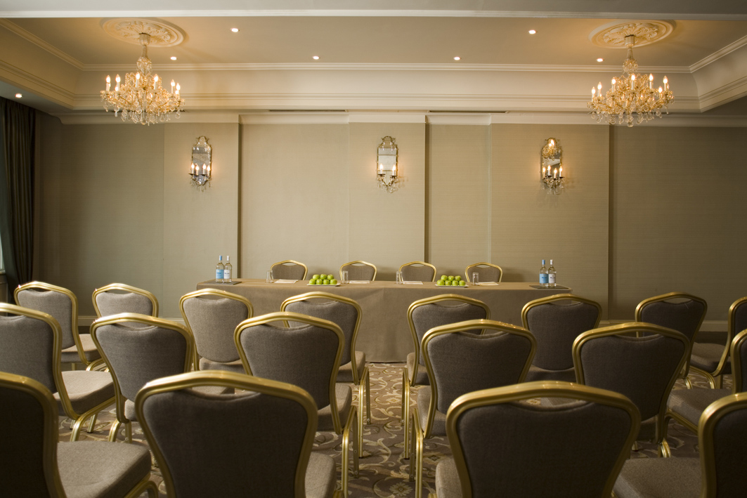 Sophisticated meeting room at L'Horizon Beach Hotel with elegant chandeliers and plush seating.