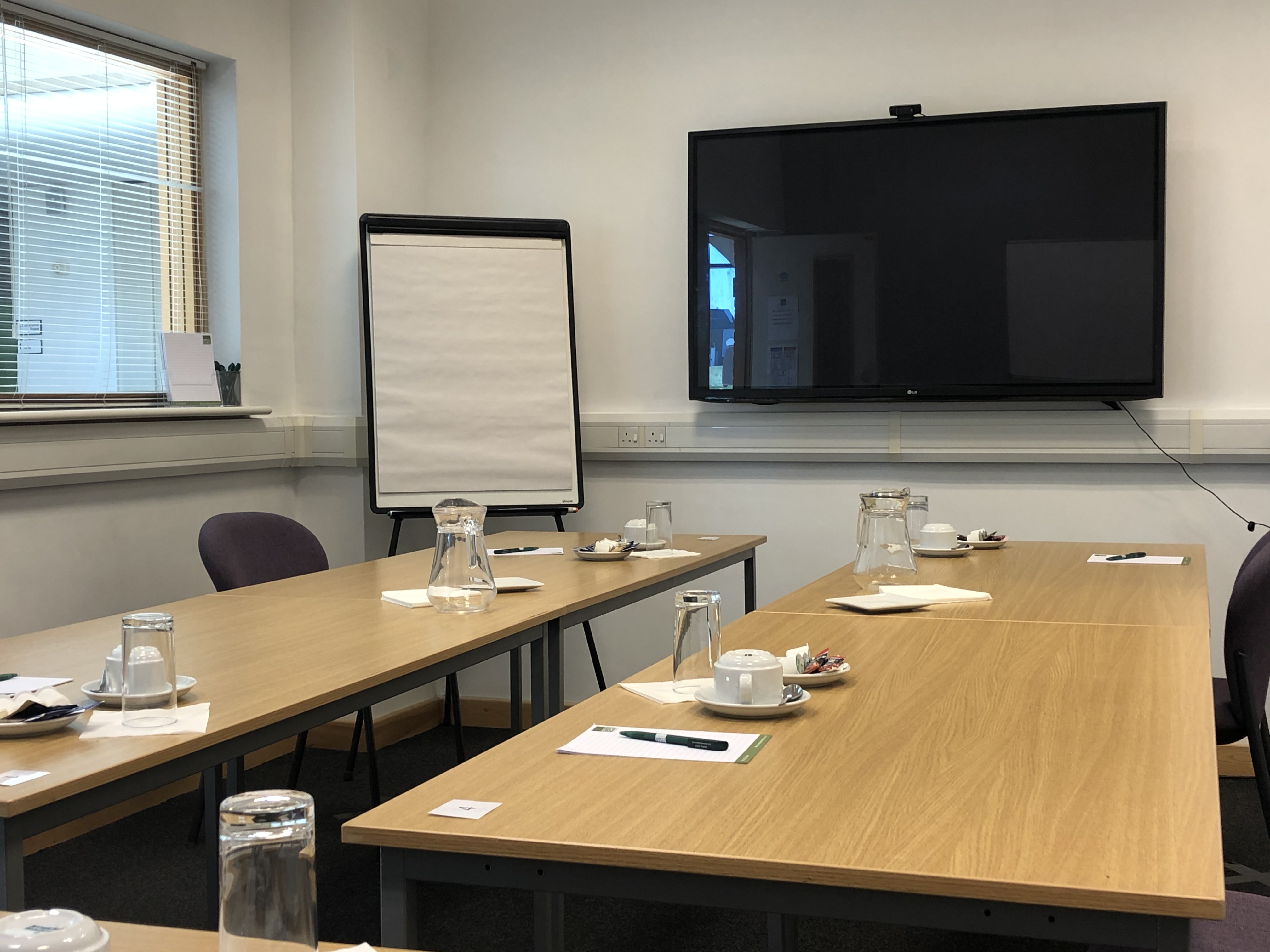 Boardroom in Capability House with central table, ideal for workshops and meetings.