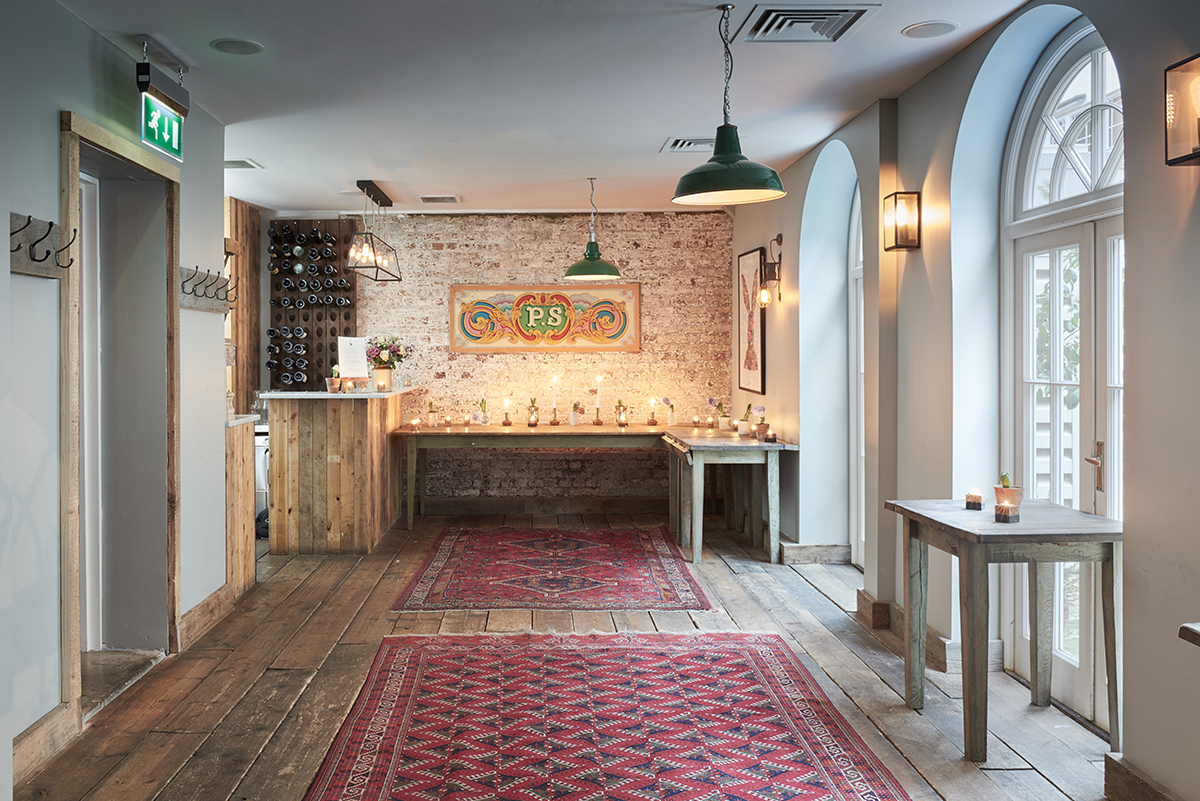 Stylish Club Room at Artist Residence London with rustic decor for events and gatherings.