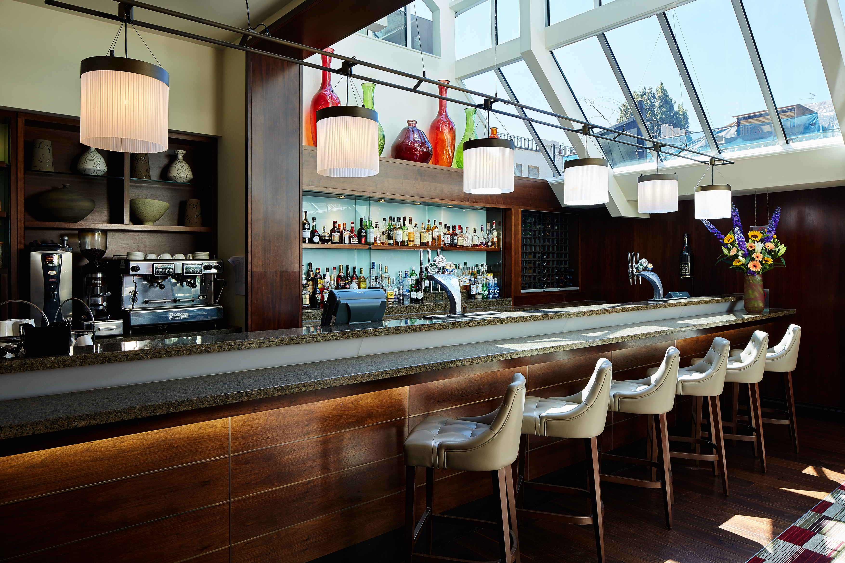 Stylish bar area in The Conservatory, ideal for networking events and social gatherings.