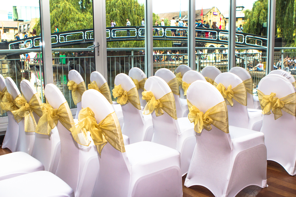 Elegant seating area with yellow sashes at Holiday Inn Camden Lock for weddings and events.