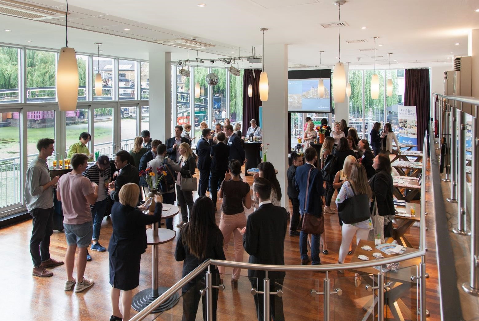 Vibrant networking event at The Glasshouse, Holiday Inn Camden Lock, with natural light.