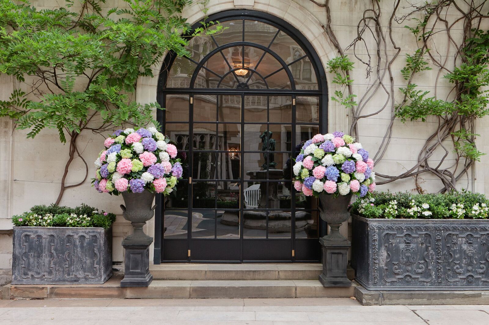 Elegant entrance with floral arrangements at Merchant Taylors' Hall for upscale events.