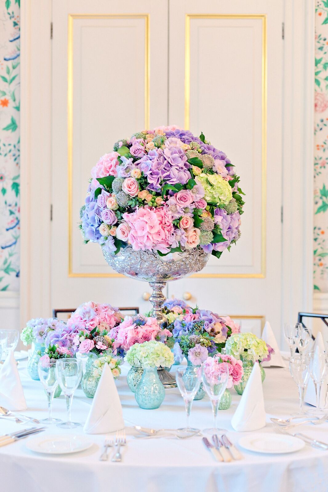 Elegant floral centerpiece of pastel roses in silver urn at Merchant Taylors' Hall.