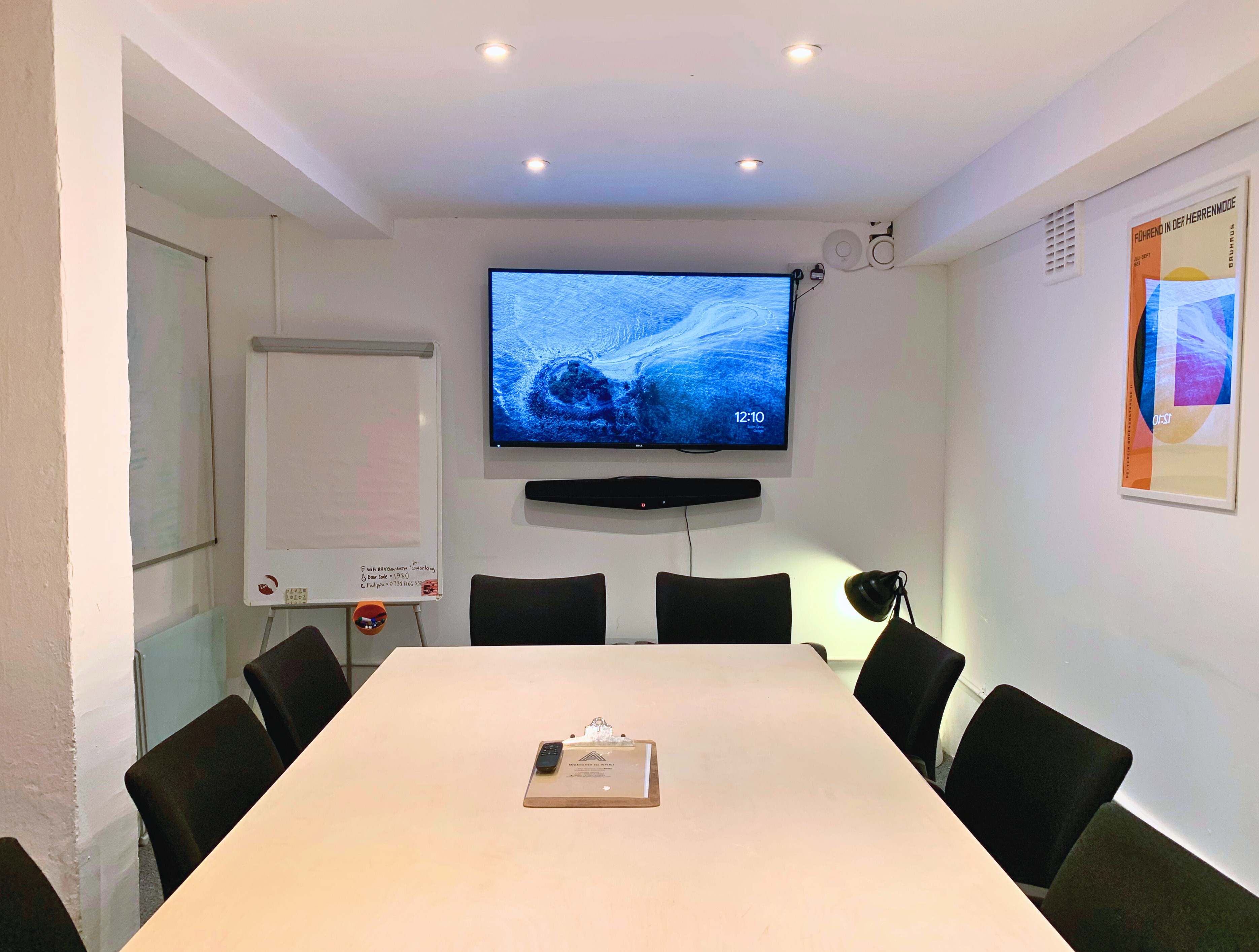 Modern boardroom in ARK coworking, ideal for meetings and workshops with large screen.