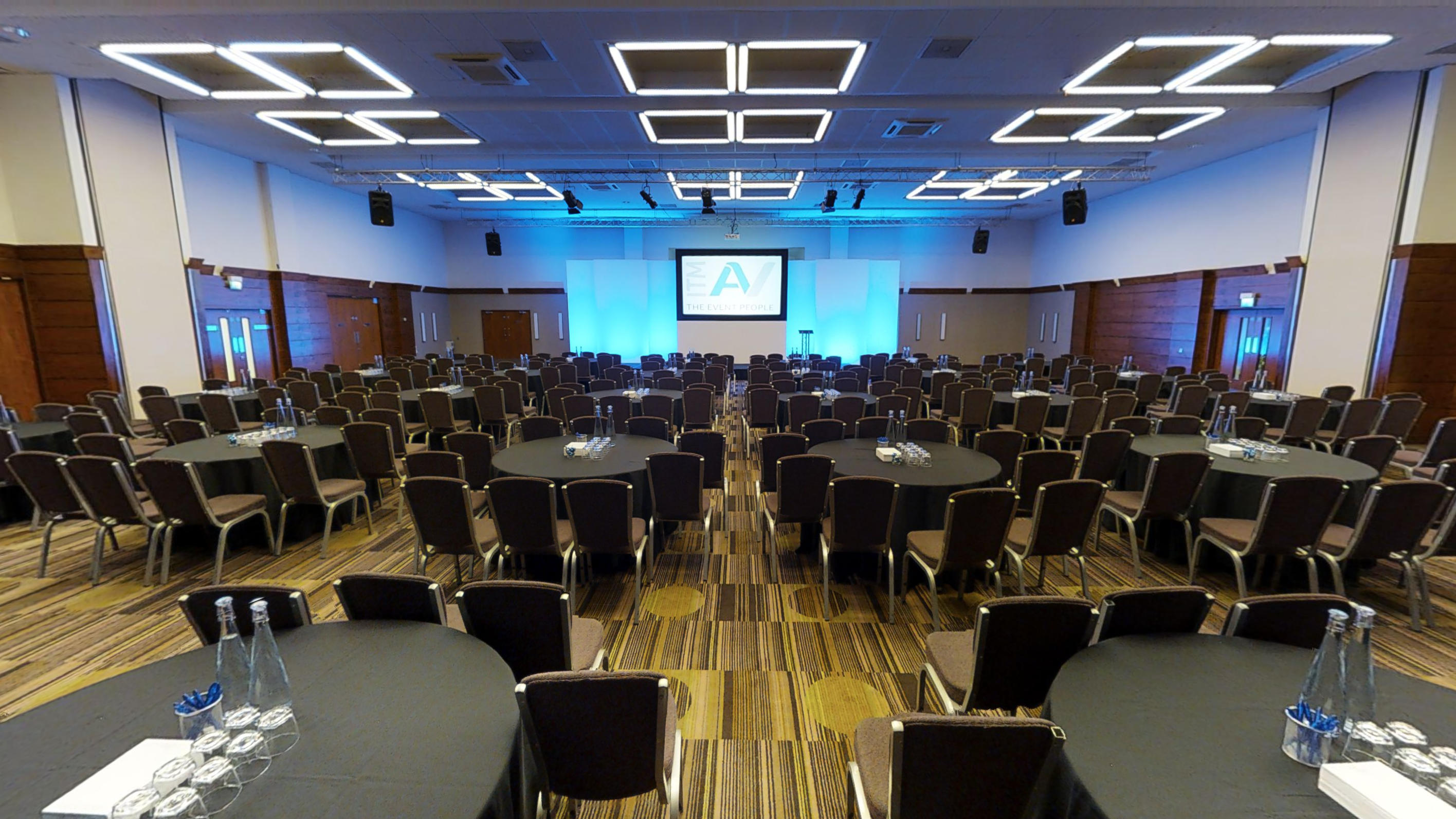 Spacious Princess Suite conference room with round tables, ideal for corporate events.