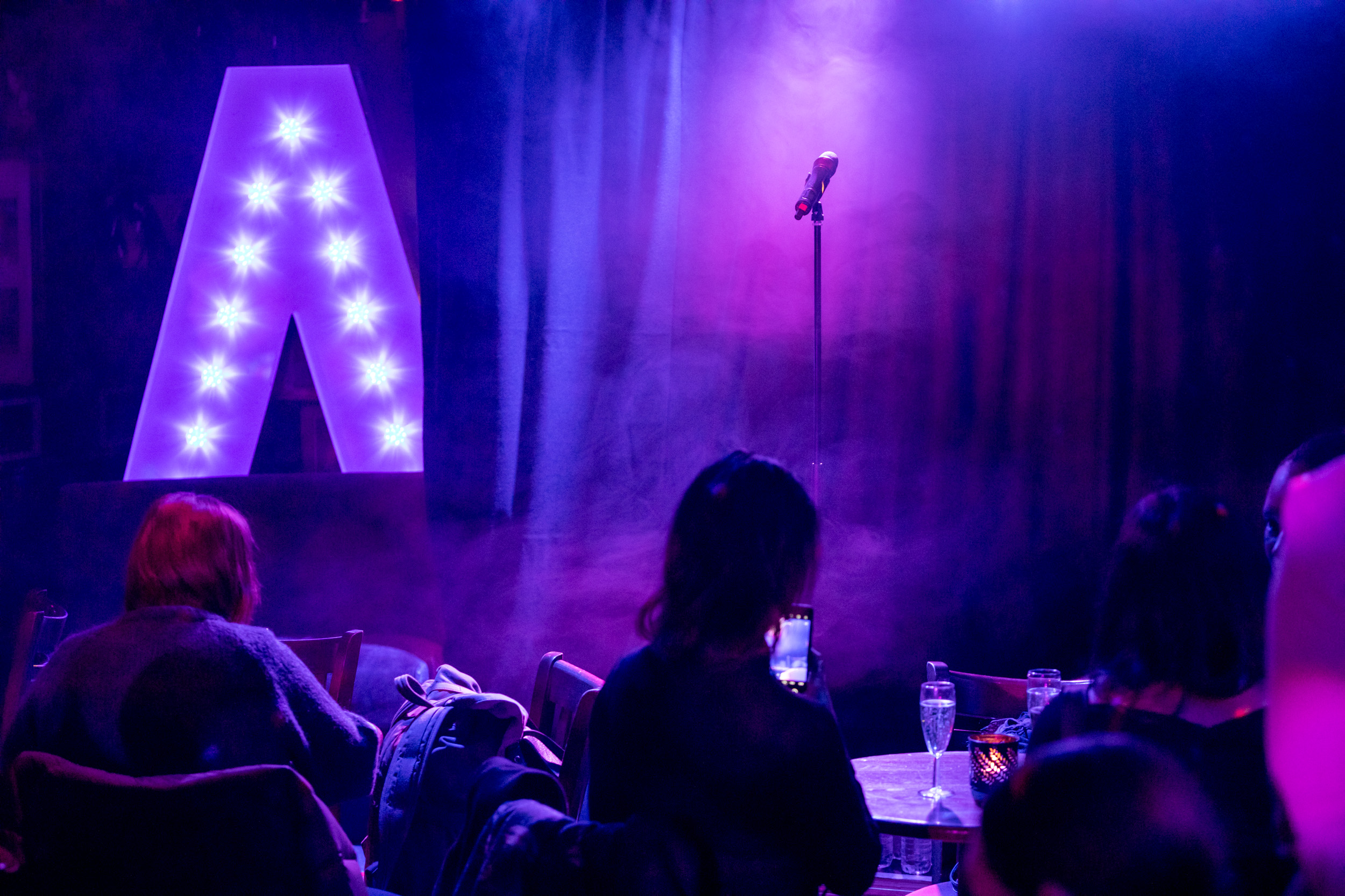 Vibrant Phoenix Arts Club venue with spotlighted microphone for live music or comedy events.