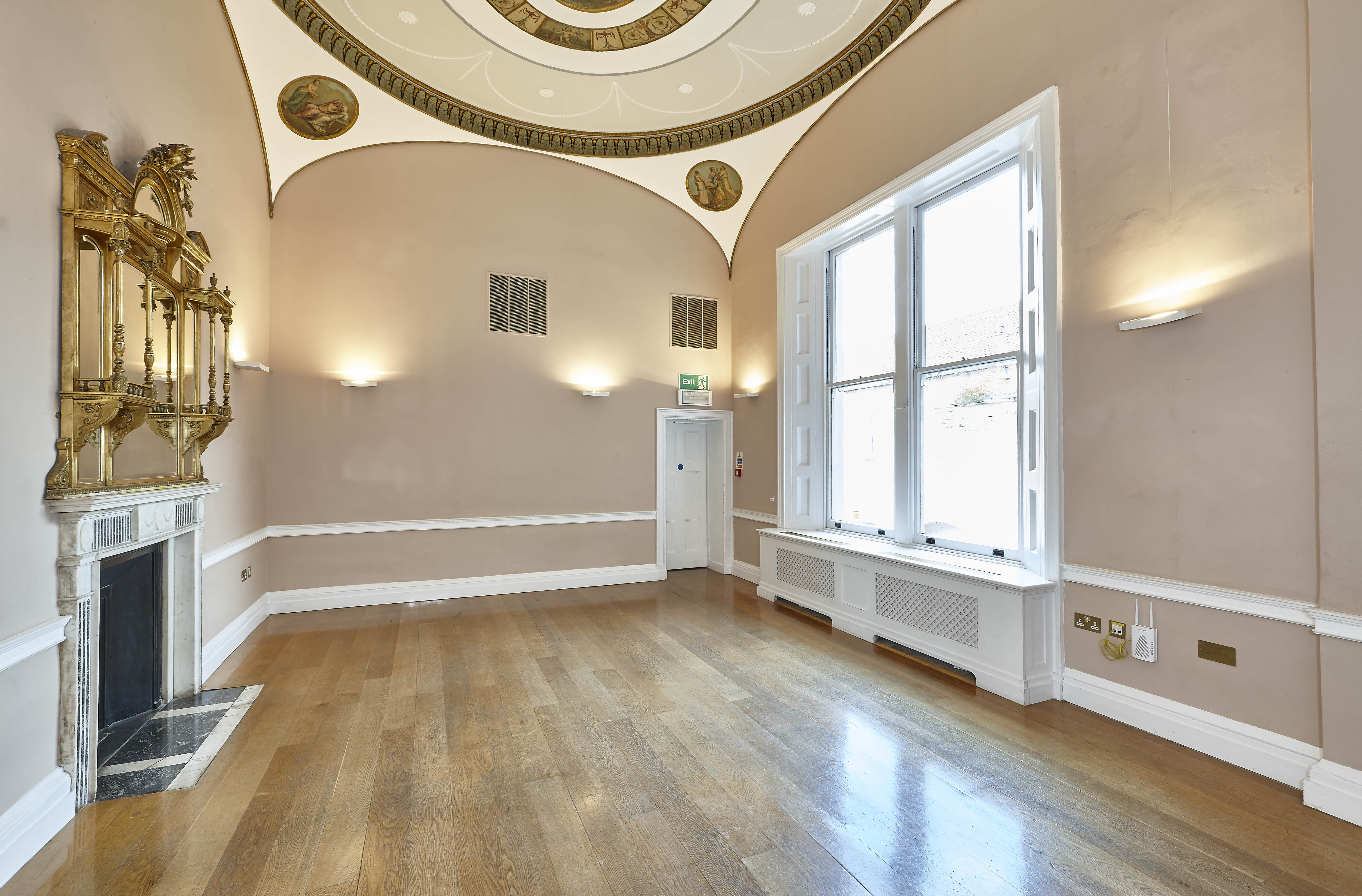 Elegant event space with high ceilings and natural light, perfect for meetings and workshops.