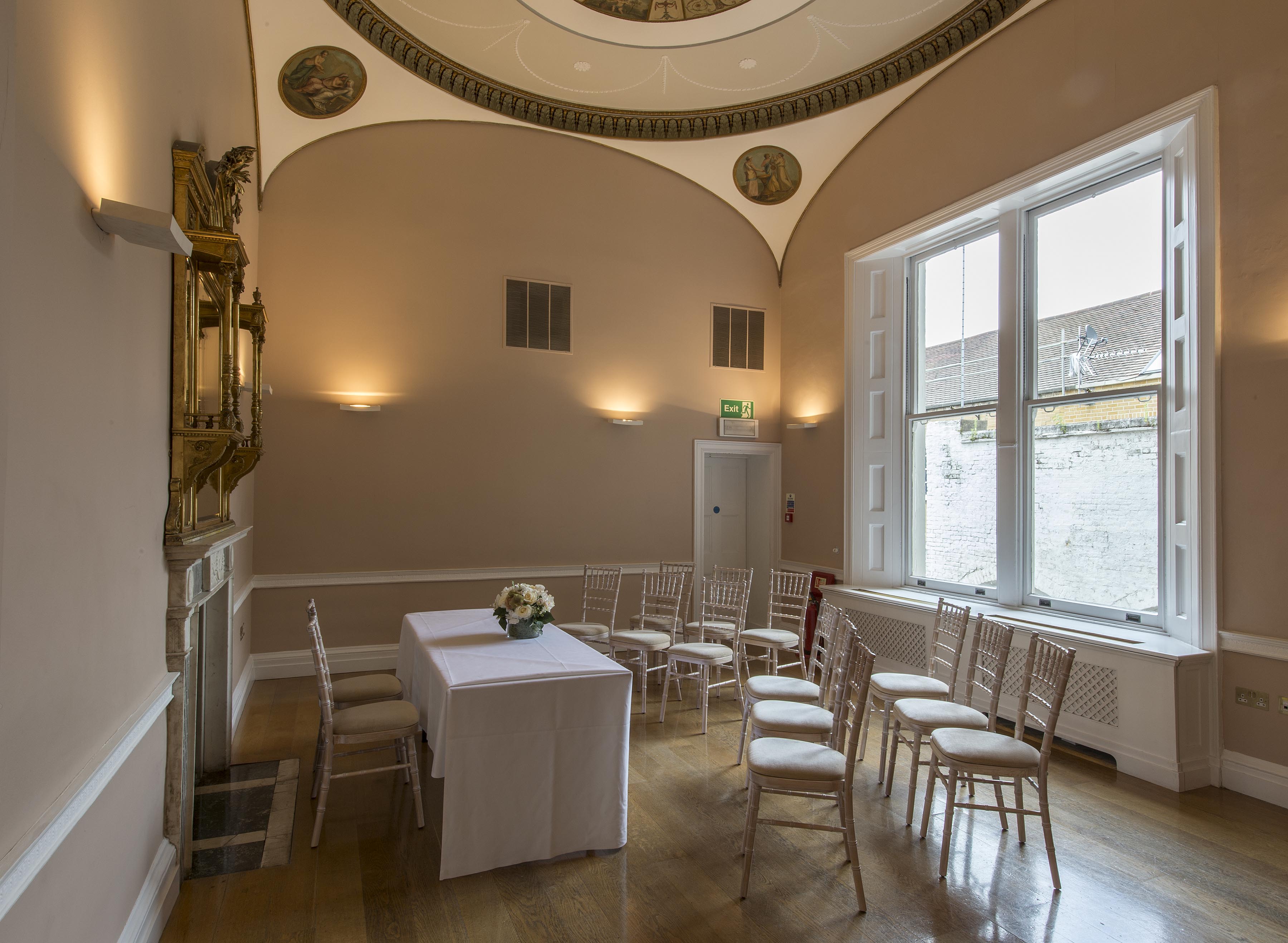 Elegant meeting room with floral centerpiece, perfect for workshops and small conferences.