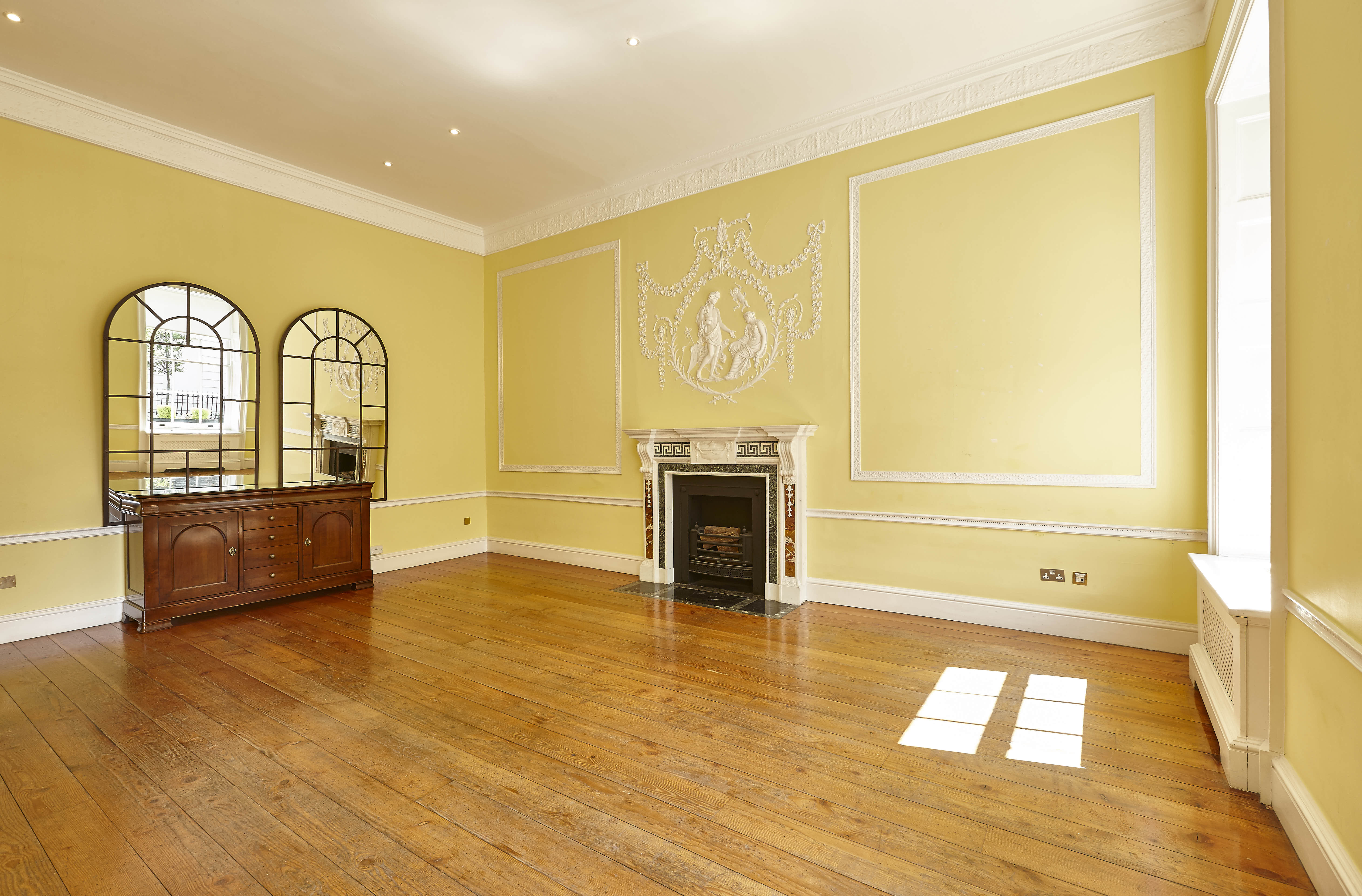 Elegant Hutchison Room with warm yellow walls, ideal for workshops and intimate events.