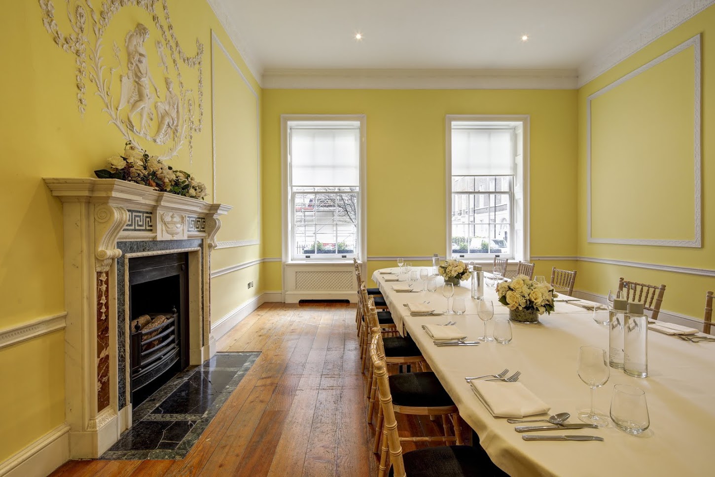 Elegant meeting room with yellow walls, ideal for events and gatherings.