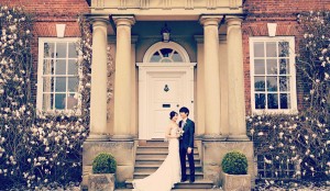 Outdoor wedding venue at Iscoyd Park with elegant couple and classic architecture.