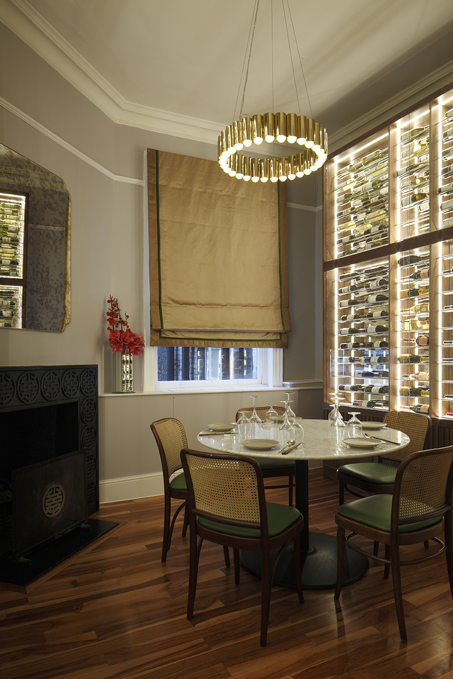 Elegant wine room with round table, ideal for intimate meetings and private events.