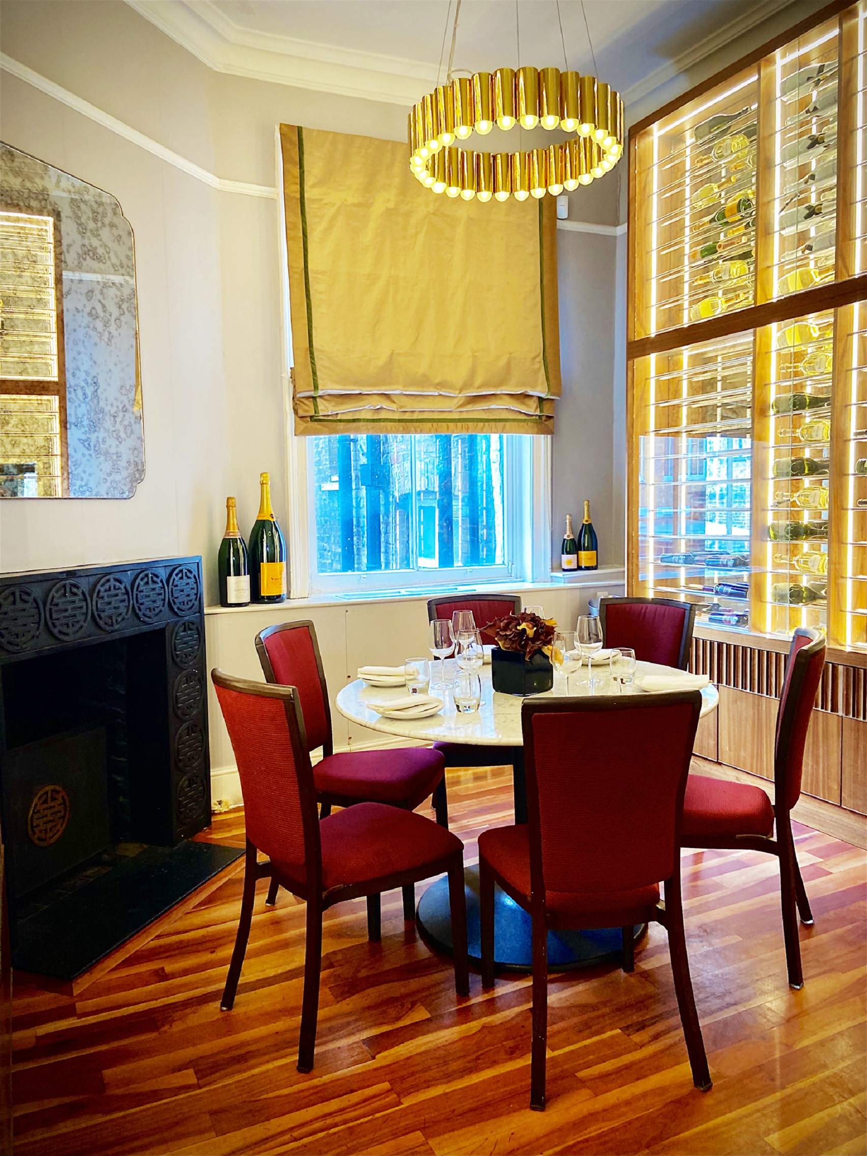 Elegant wine room with round table, ideal for private events and networking.