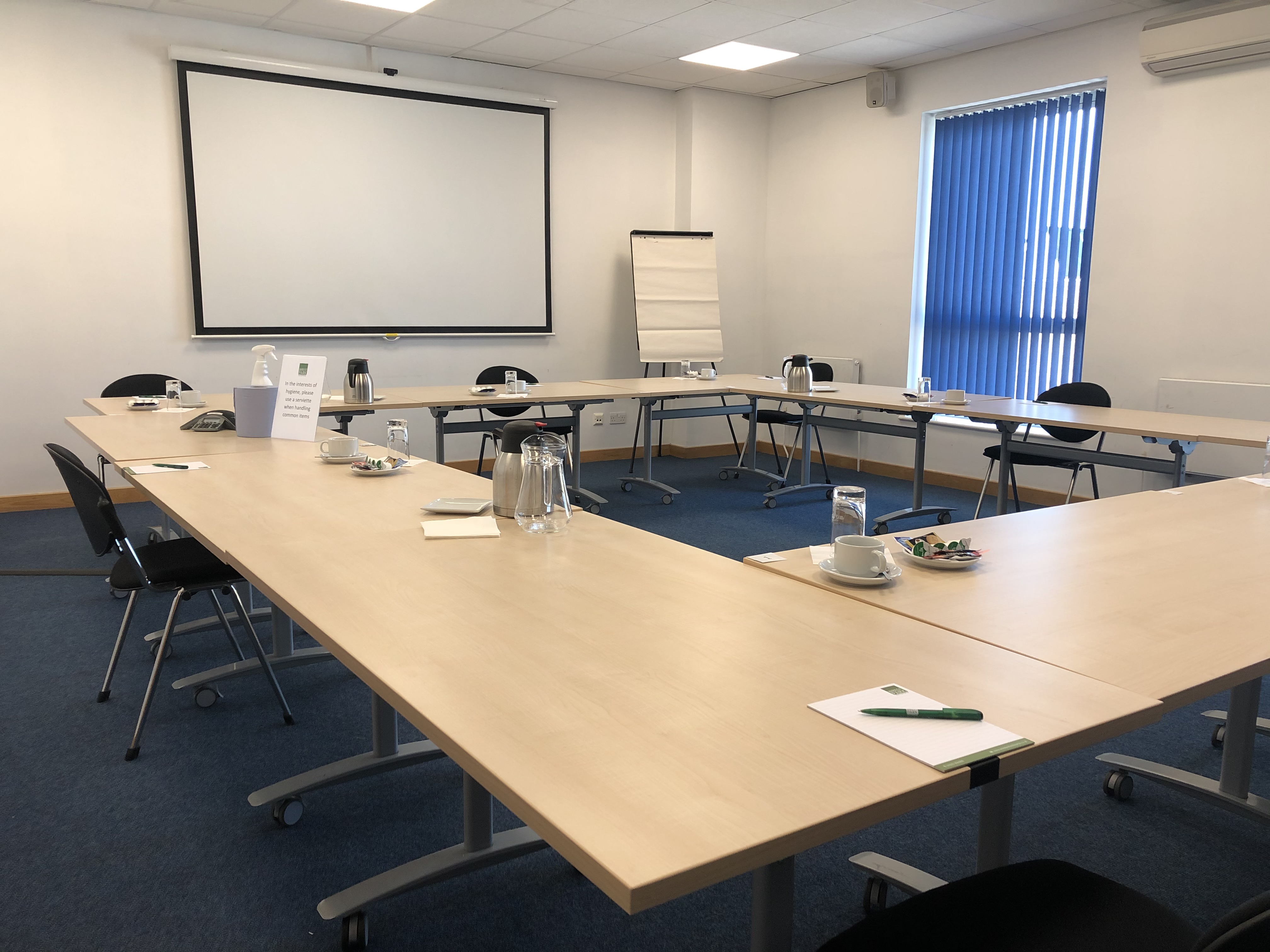 Training Room in Endeavour House with U-shaped table for professional meetings and presentations.