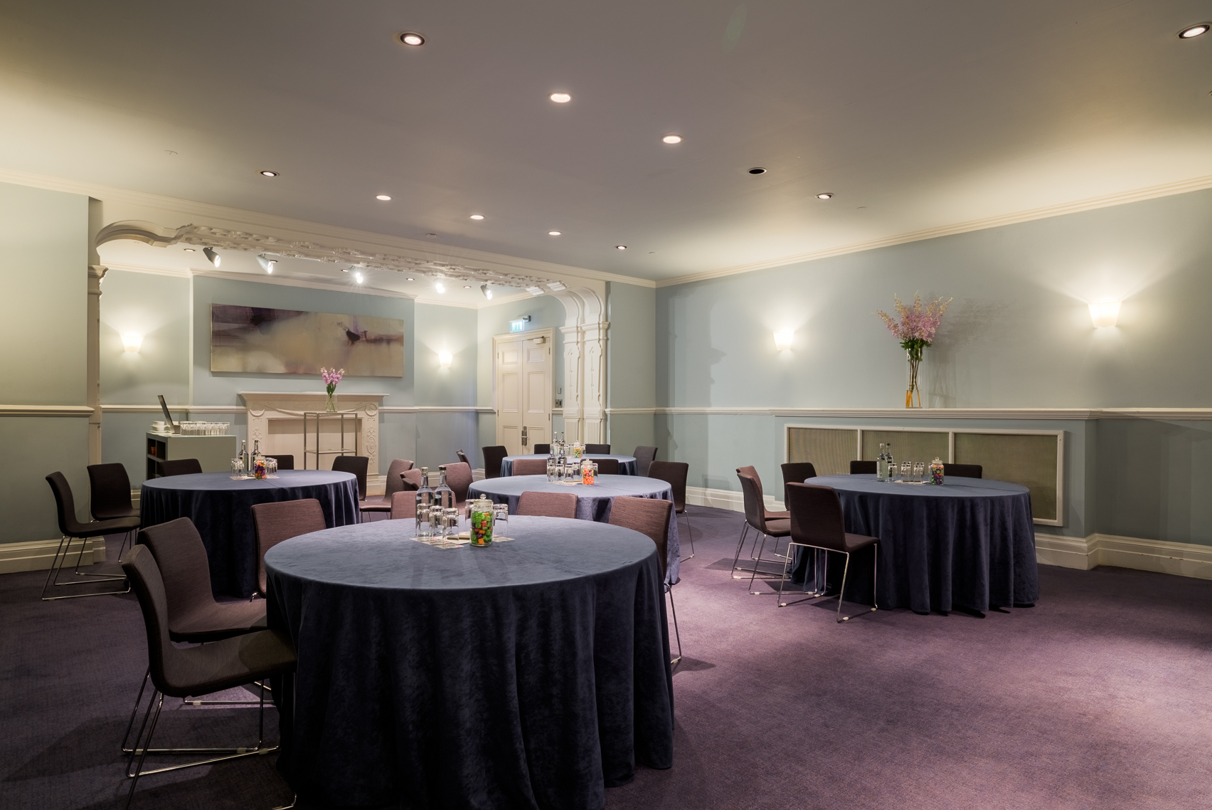 Elegant meeting space at Andaz London with round tables for corporate events.