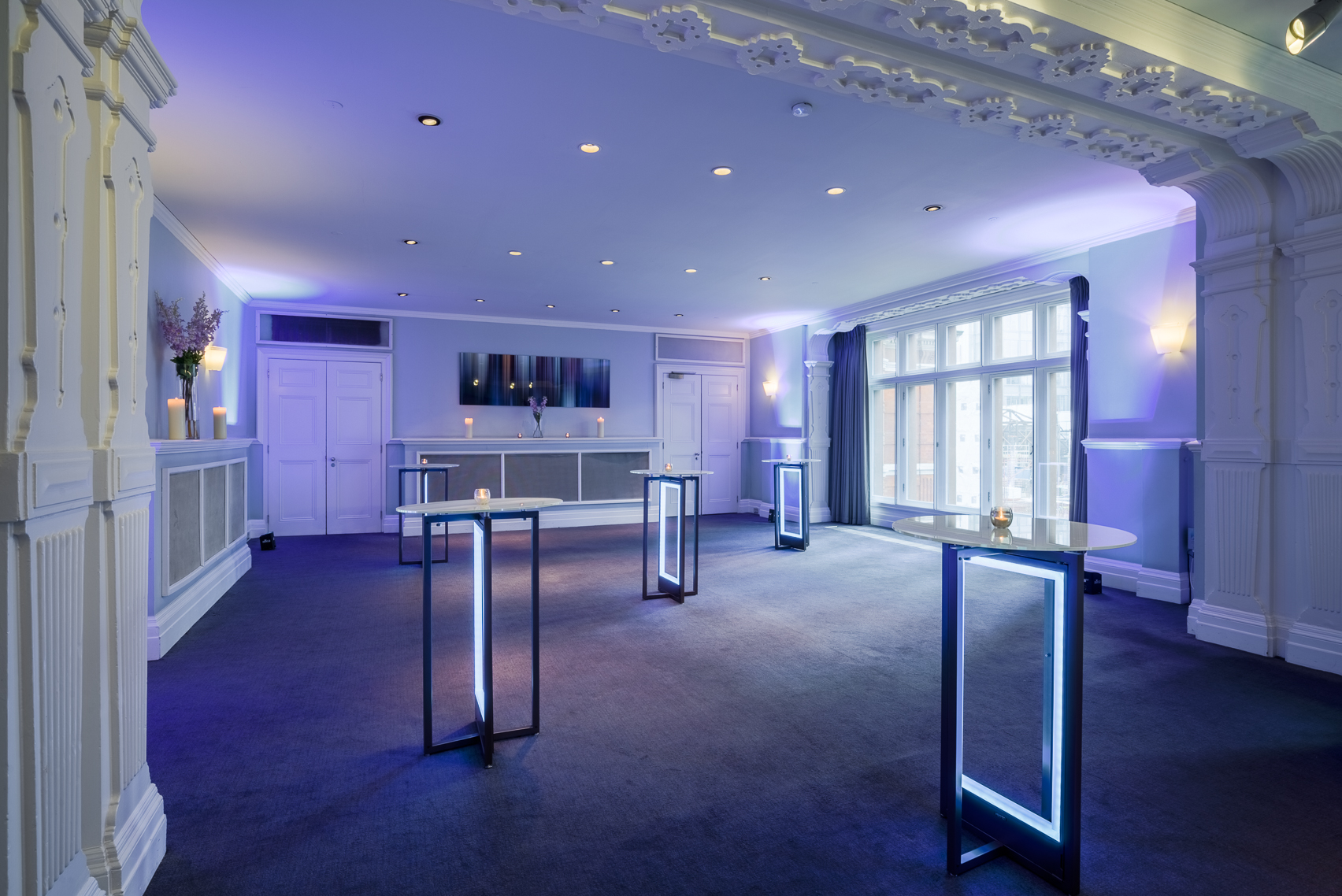 Stylish event space at The Minories, Andaz London with illuminated cocktail tables.
