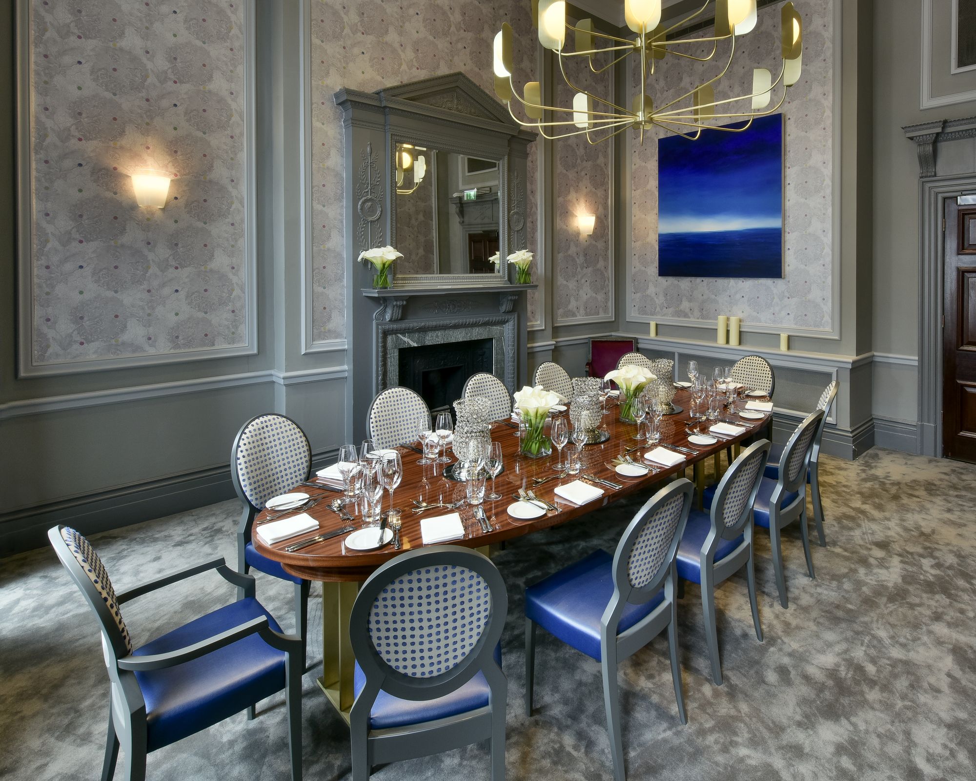 Elegant meeting room at Andaz London, featuring a polished table and floral decor.