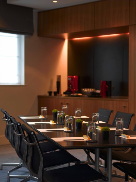 Broadgate Suite meeting room at Andaz London, featuring a sleek table and greenery.