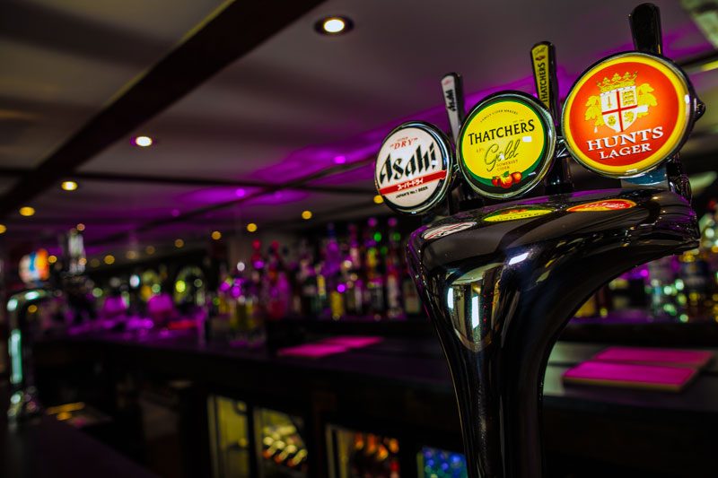 Hunt's Lounge bar with vibrant lighting, perfect for networking events and receptions.