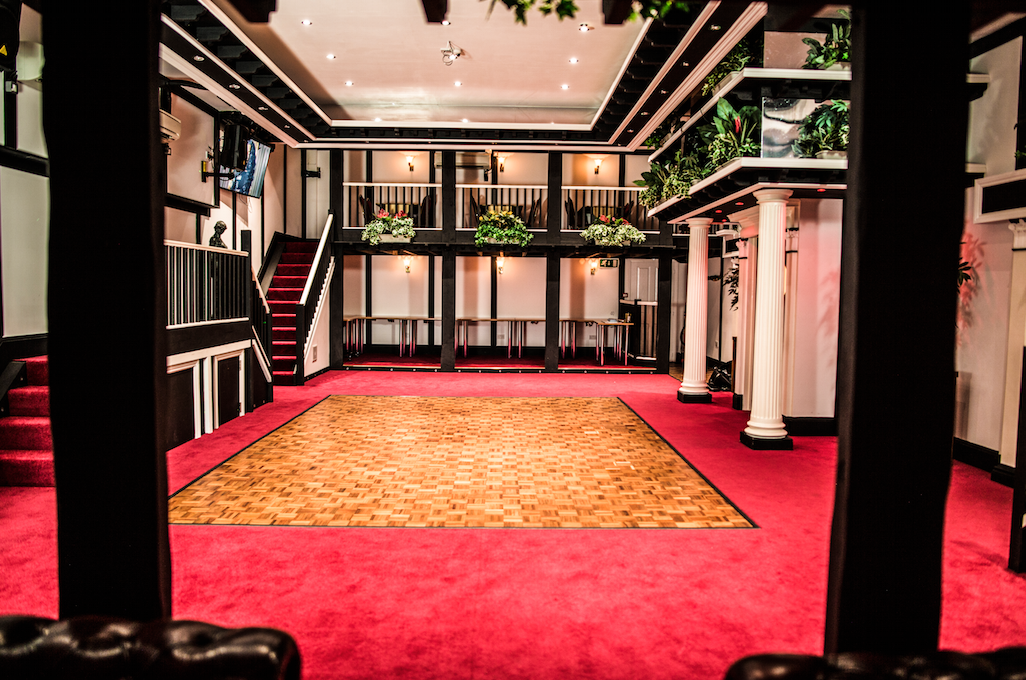 Hunt's Lounge event space with polished dance floor, ideal for presentations and gatherings.
